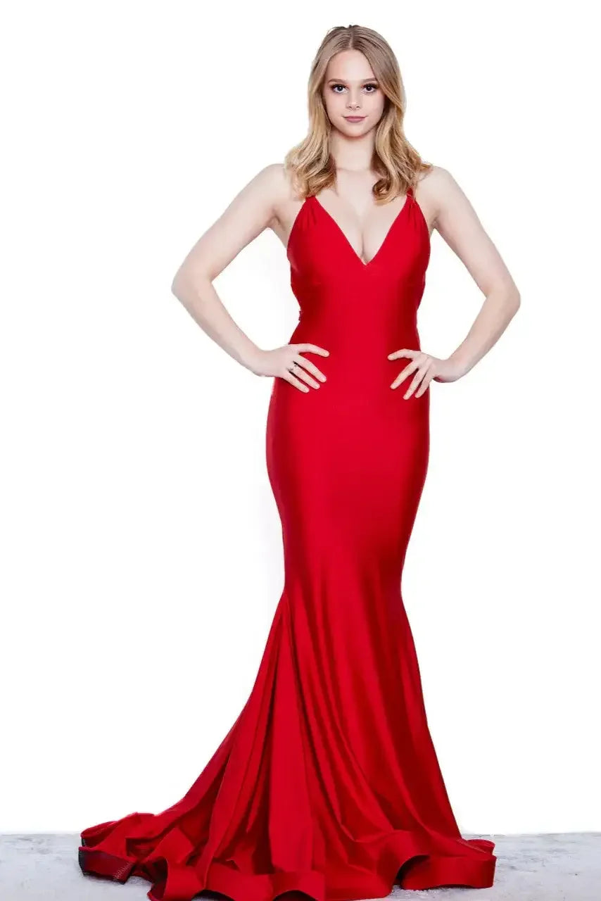 A woman stands confidently in a form-fitting, floor-length red dress. She poses with hands on her hips against a plain white background, emphasizing the dress's elegant silhouette.