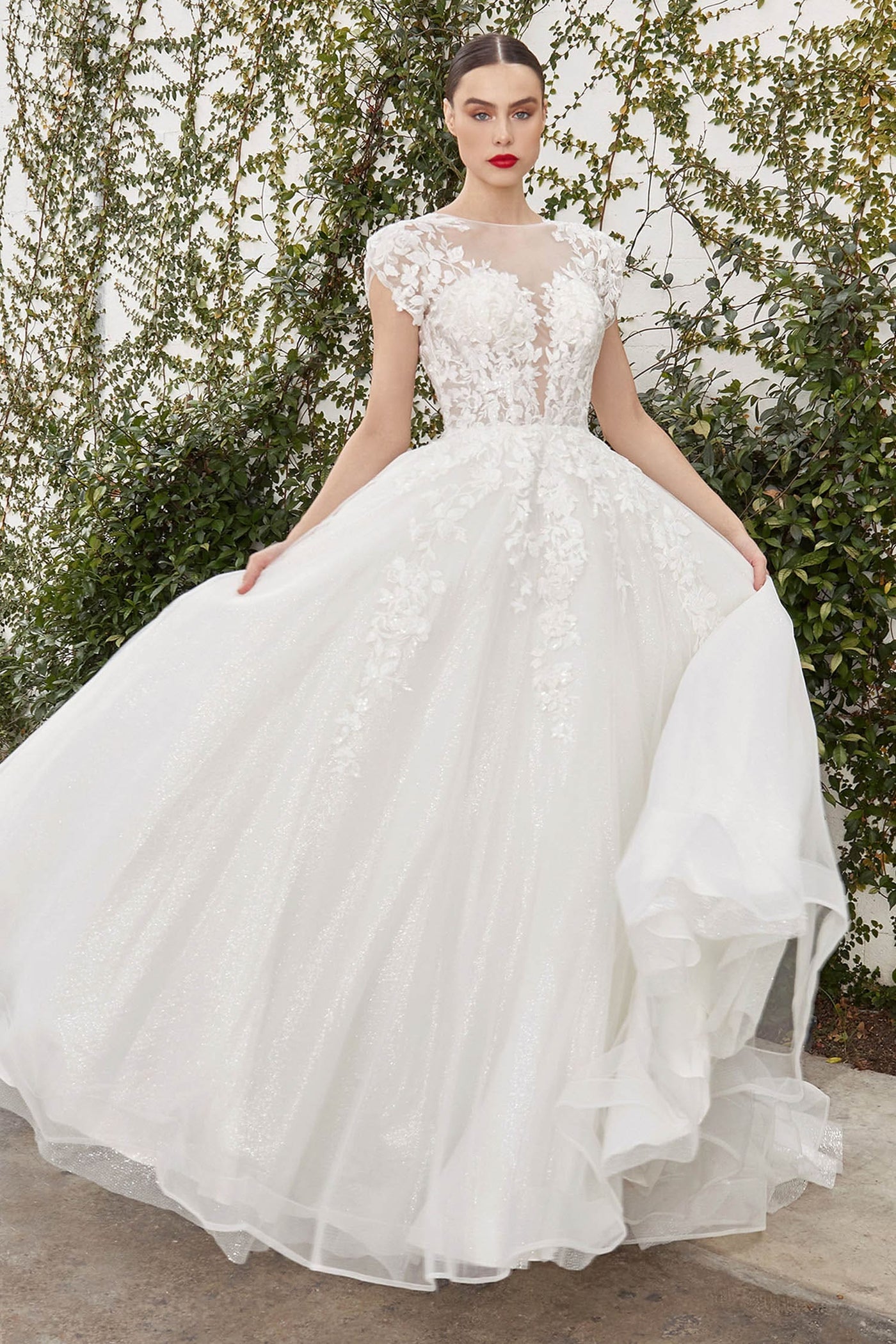 White wedding dress with floral details against a natural background