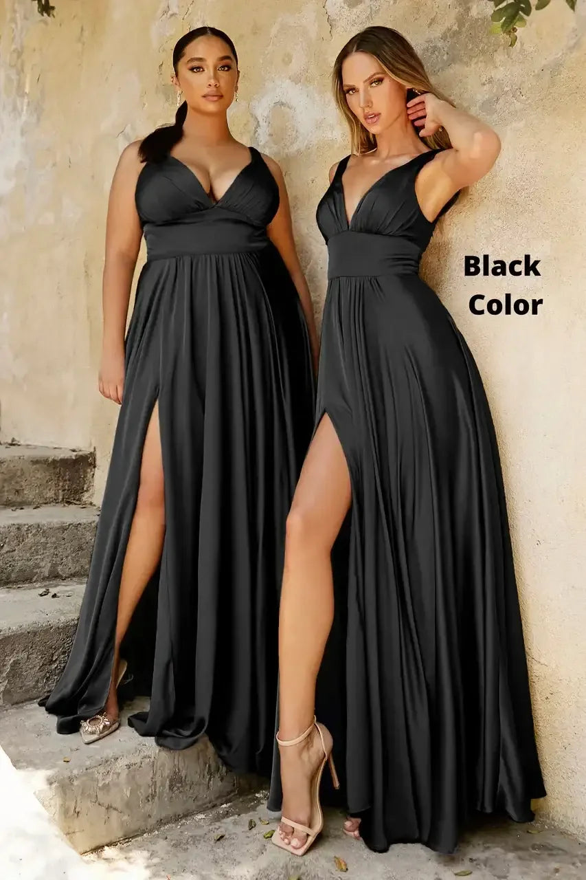 Two women wear elegant, black, floor-length dresses with leg slits, standing on stone steps against a textured wall. One woman poses confidently while the other lightly touches her hair. Text reads "Black Color."