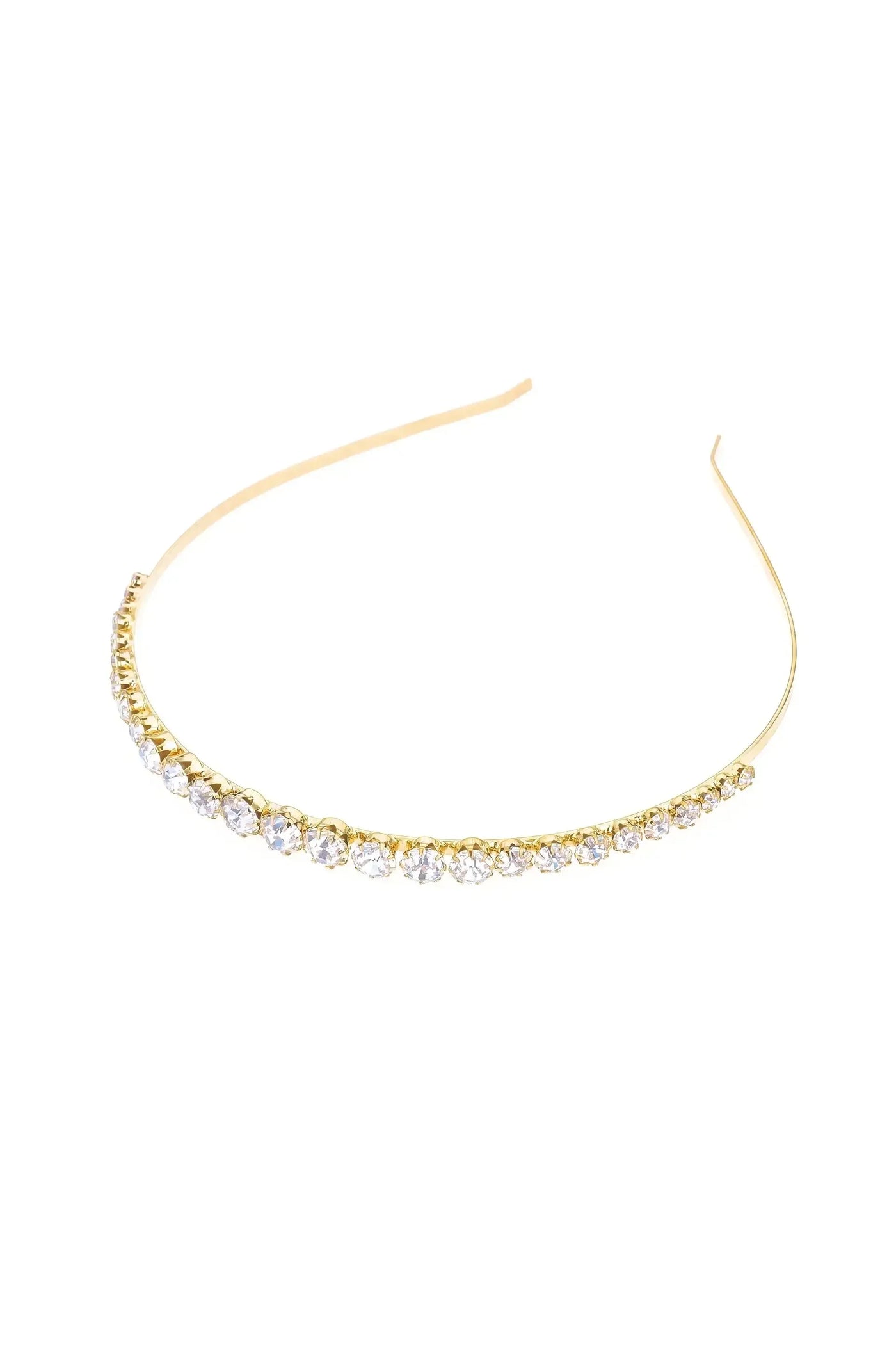 A delicate gold headband adorned with a line of sparkling crystals. It rests on a plain white background, highlighting its elegant and refined design.
