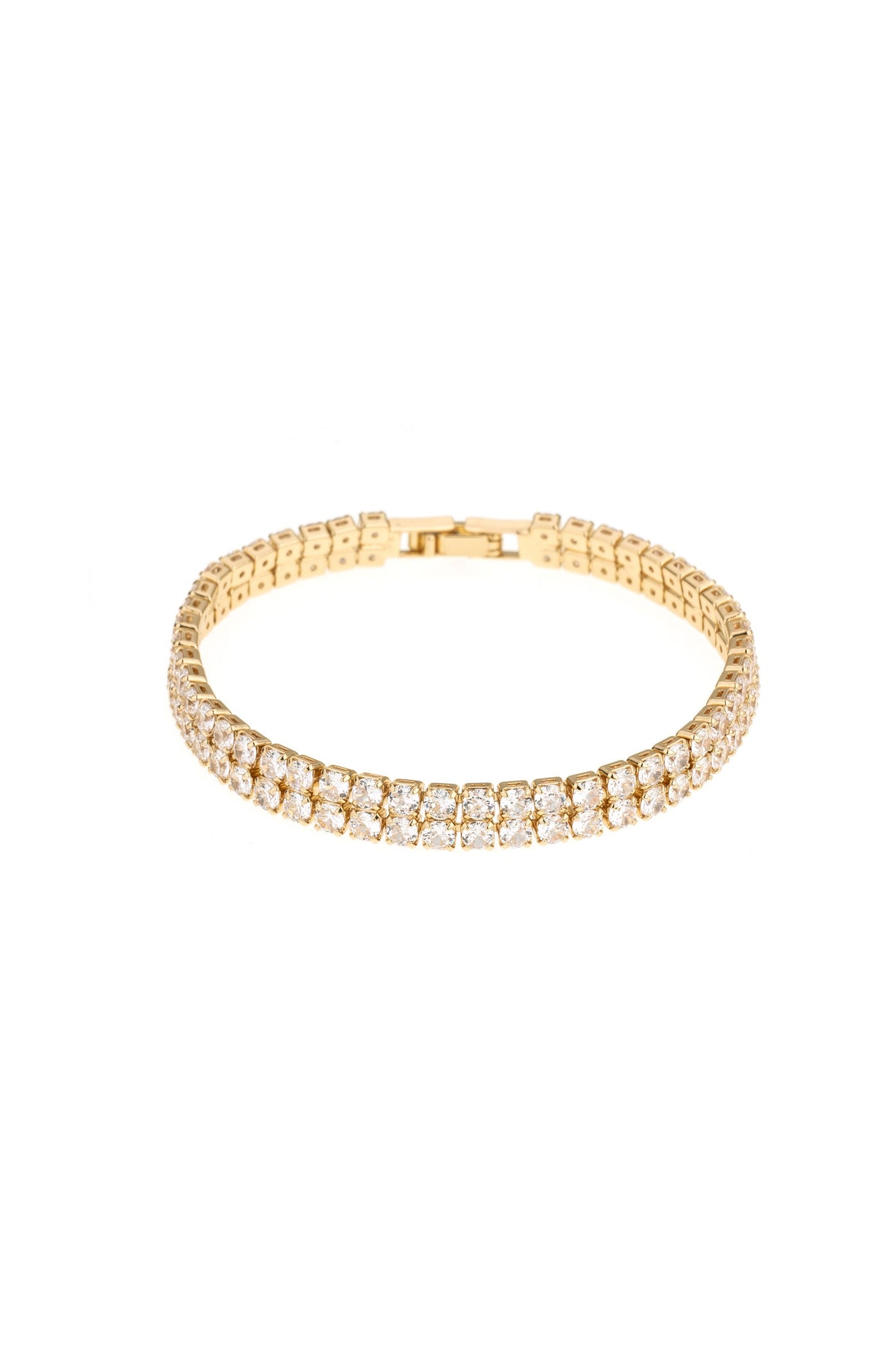 A gold bracelet adorned with sparkling clear gems, designed to fit snugly around a wrist, is showcased against a plain white background, emphasizing its elegance and shine.