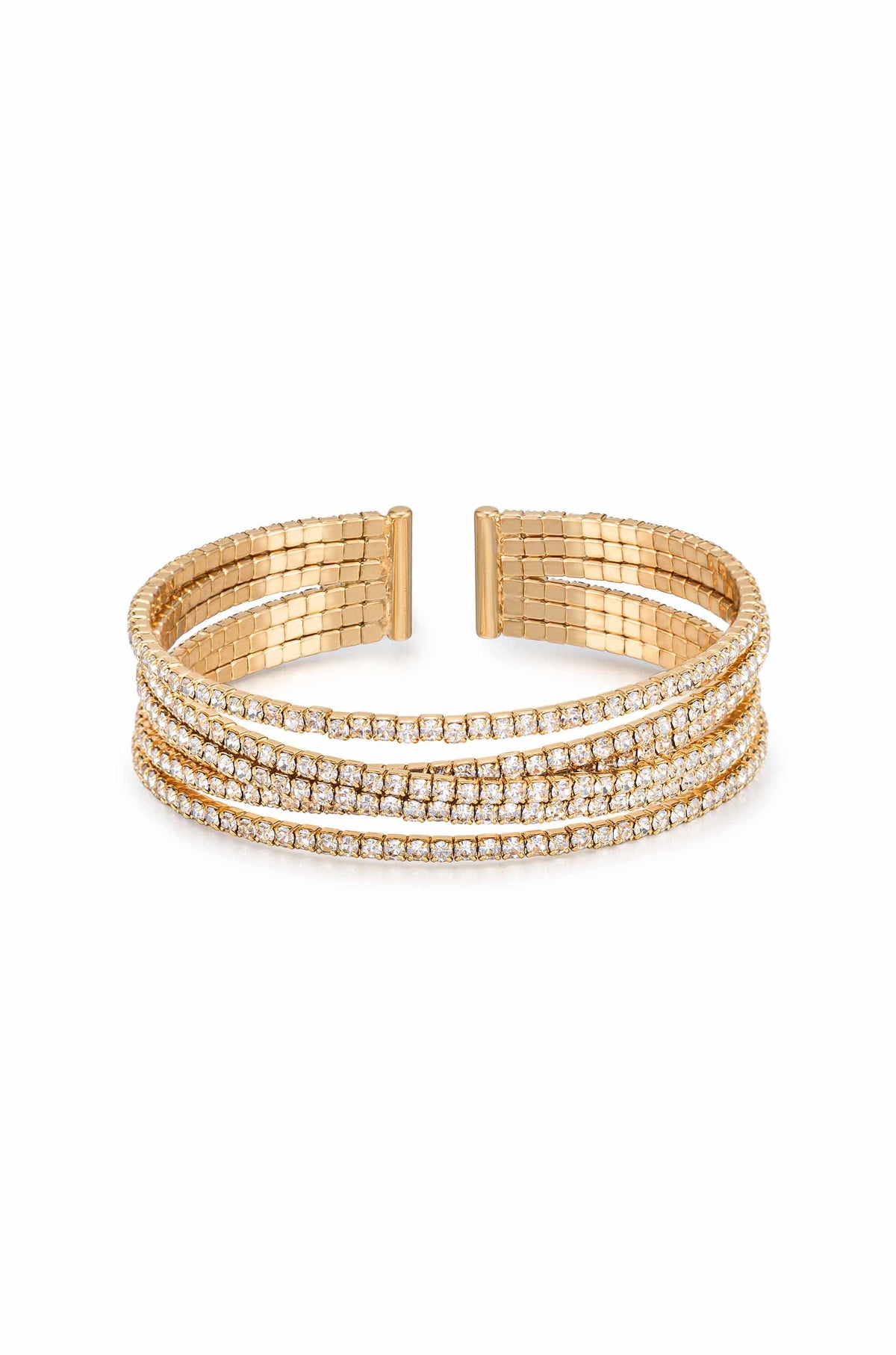 A gold cuff bracelet featuring three intertwined strands, adorned with sparkling clear gemstones. It rests against a plain white background, emphasizing its elegant design and glimmering accents.