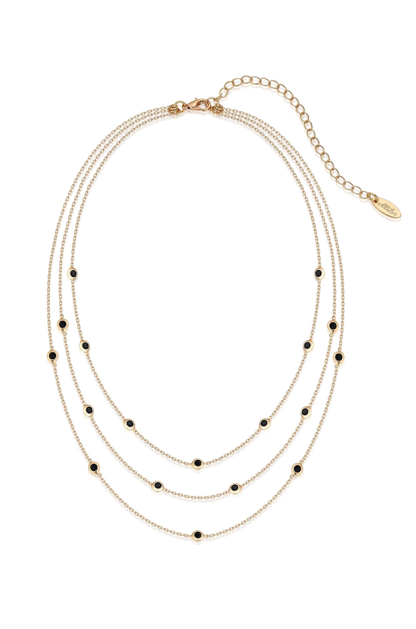A layered gold necklace features multiple delicate chains adorned with small black embellishments, elegantly displaying a combination of shine and contrast in a clean, white background setting.