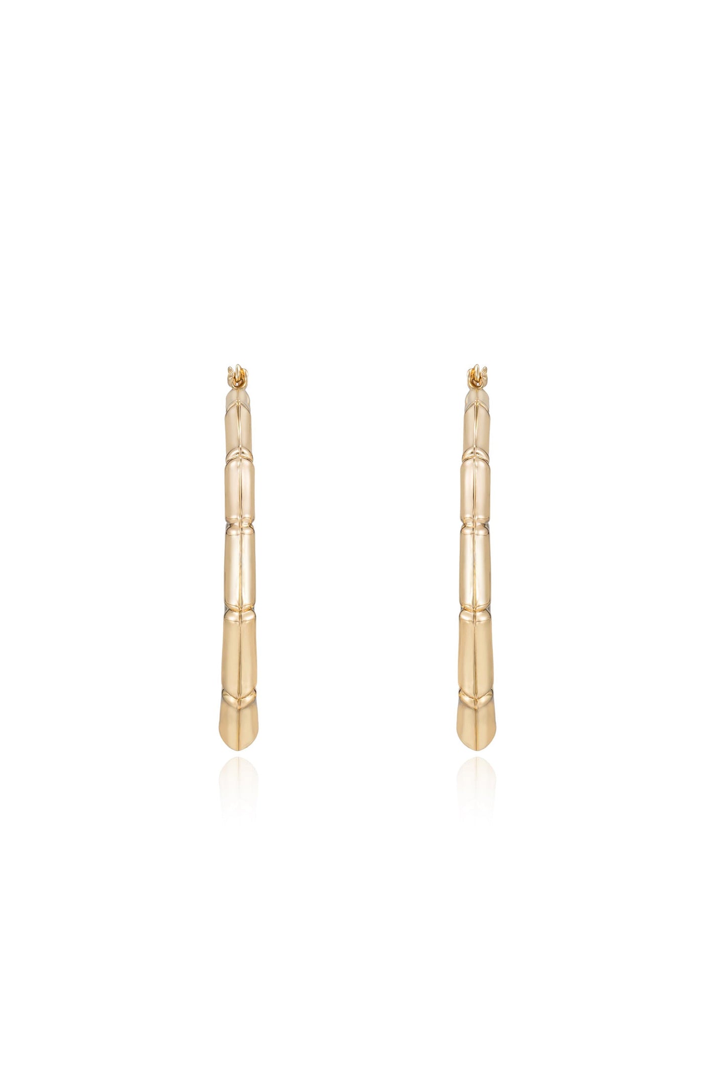 Gold earrings resembling bamboo stalks stand upright against a plain white background, showcasing their textured finish and polished shine, emphasizing an elegant, modern design.