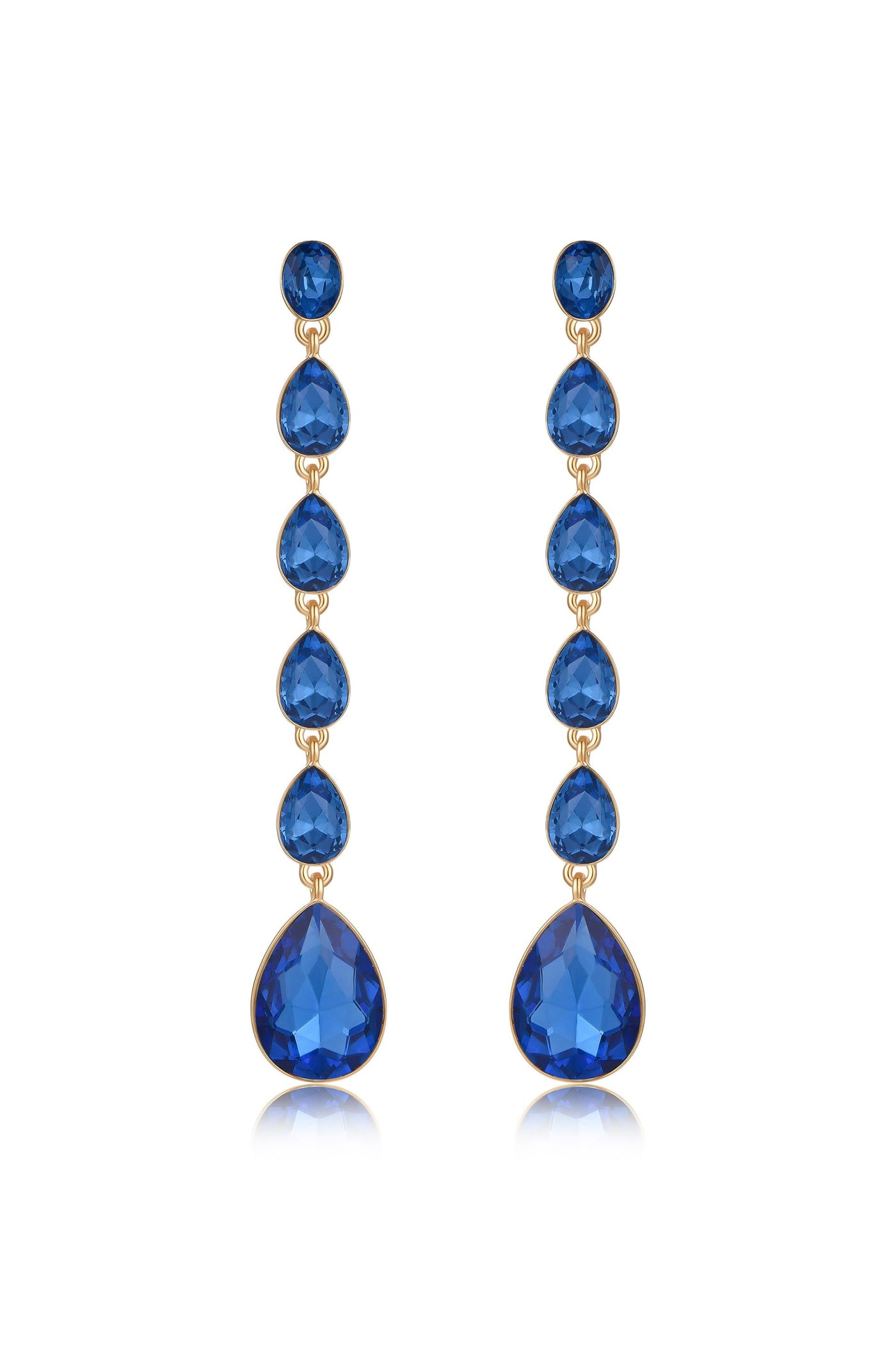 Dangle earrings feature multiple blue gemstones in teardrop and round shapes, strung together in a vertical arrangement. They are set against a plain white background, enhancing their elegance.
