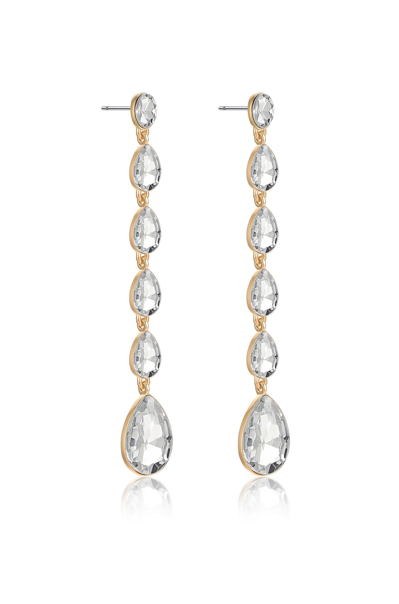 Long, elegant earrings made of transparent, teardrop-shaped stones hang from thin posts. The stones are connected by gold-toned metal links, reflecting light in a simple, stylish design.