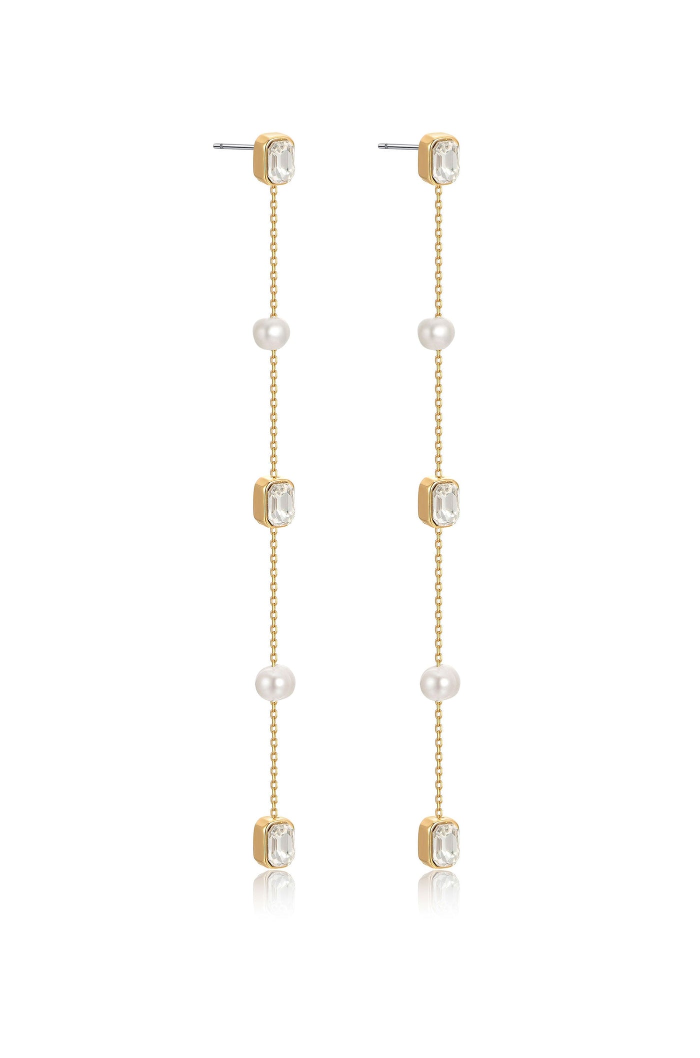 Long, elegant earrings feature alternating gold, crystal, and pearl elements. They dangle gracefully, reflecting light, suitable for formal or festive occasions. The background is neutral, emphasizing the earrings' design.