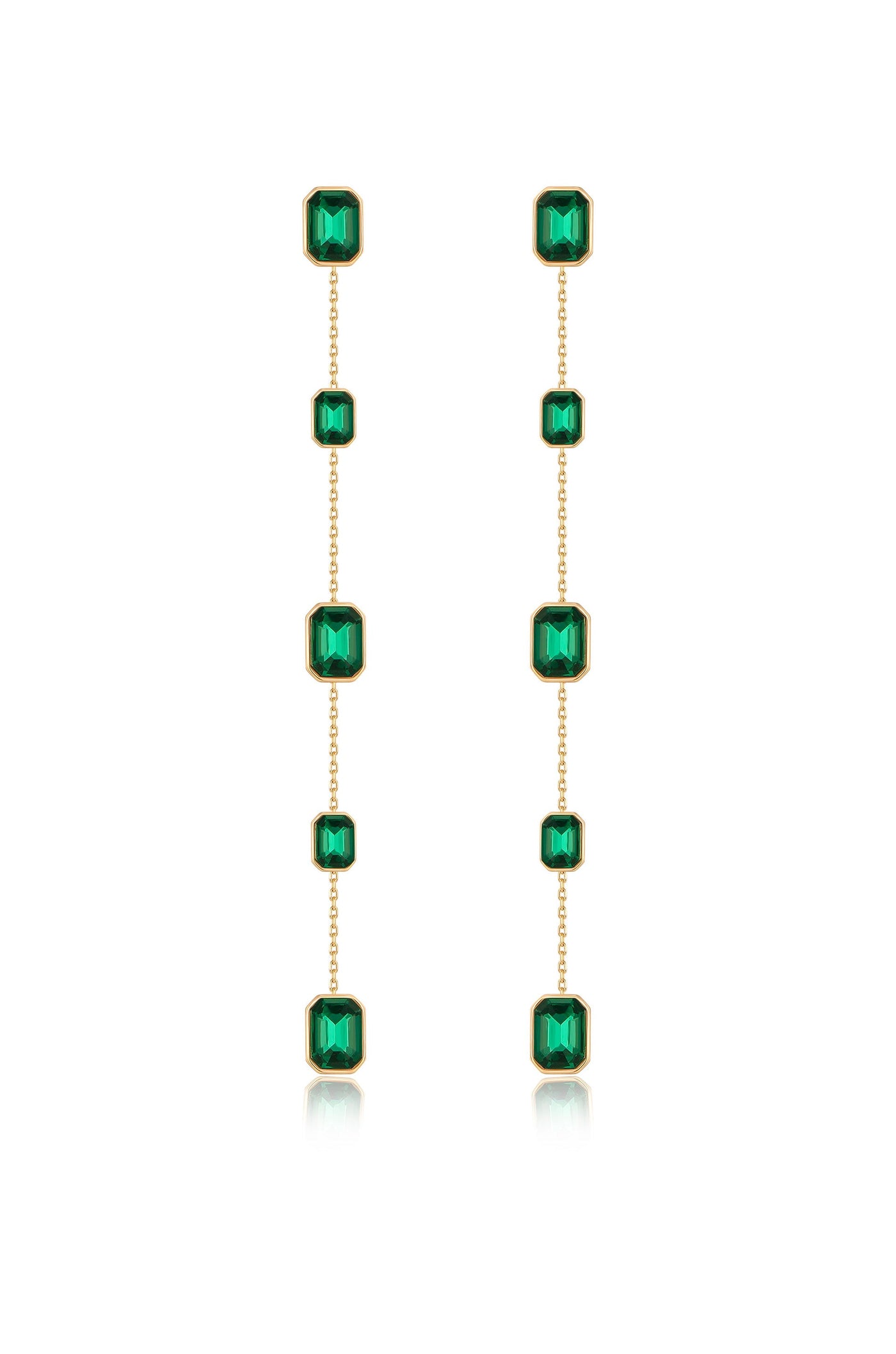 Two dangling earrings are displayed, featuring a series of rectangular green gemstones set in gold. They hang vertically, reflecting light against a white background.
