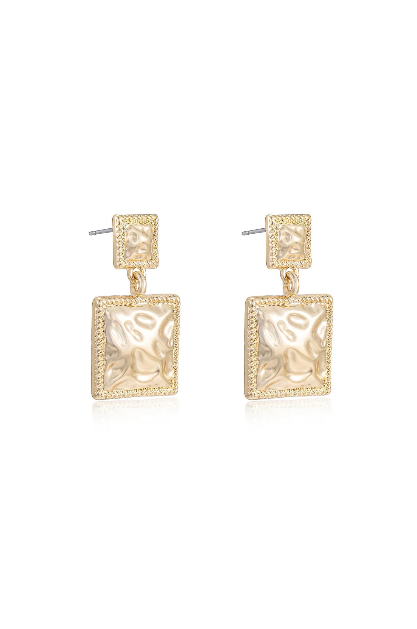 Gold earrings hang vertically, featuring square shapes with a textured surface. The shiny metal reflects light, highlighting its smooth and intricate design against a plain white background.