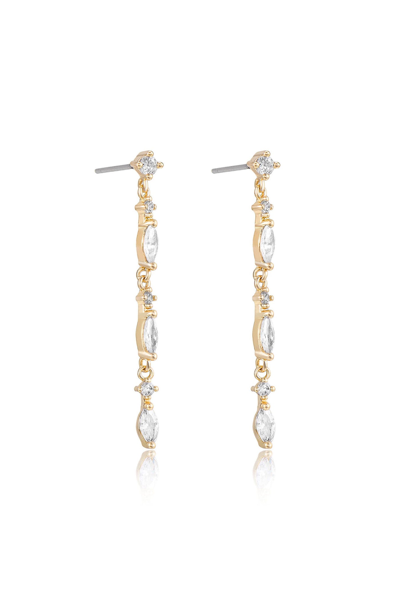Dangle earrings are showcased, featuring elongated gold links adorned with clear gemstones. They are positioned against a light backdrop, reflecting a subtle shine.