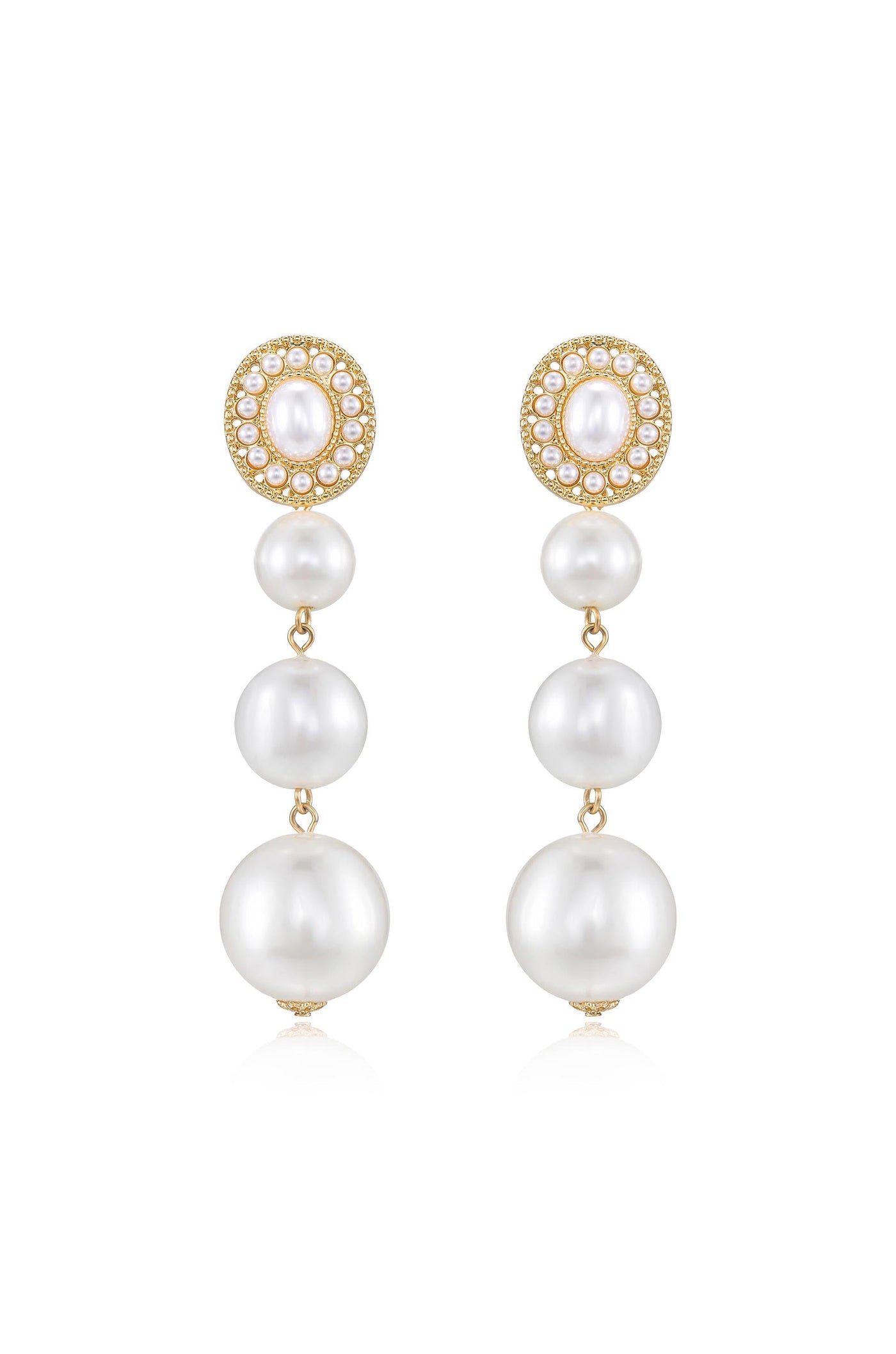 Elegant dangle earrings feature a cluster of four cascading white pearls, topped with a round, bejeweled gold setting. They reflect light, suggesting a formal or luxurious context.