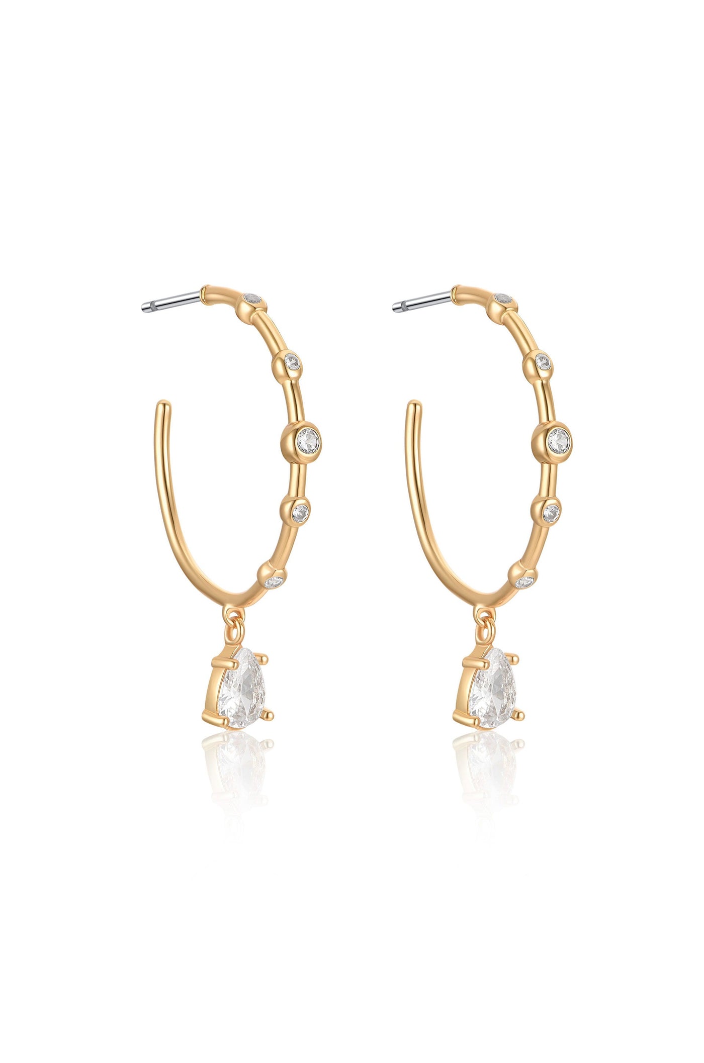 Gold hoop earrings feature a bamboo-like design with small clear stones embedded. Each earring has a pear-shaped crystal hanging from the bottom, reflecting light against a simple background.