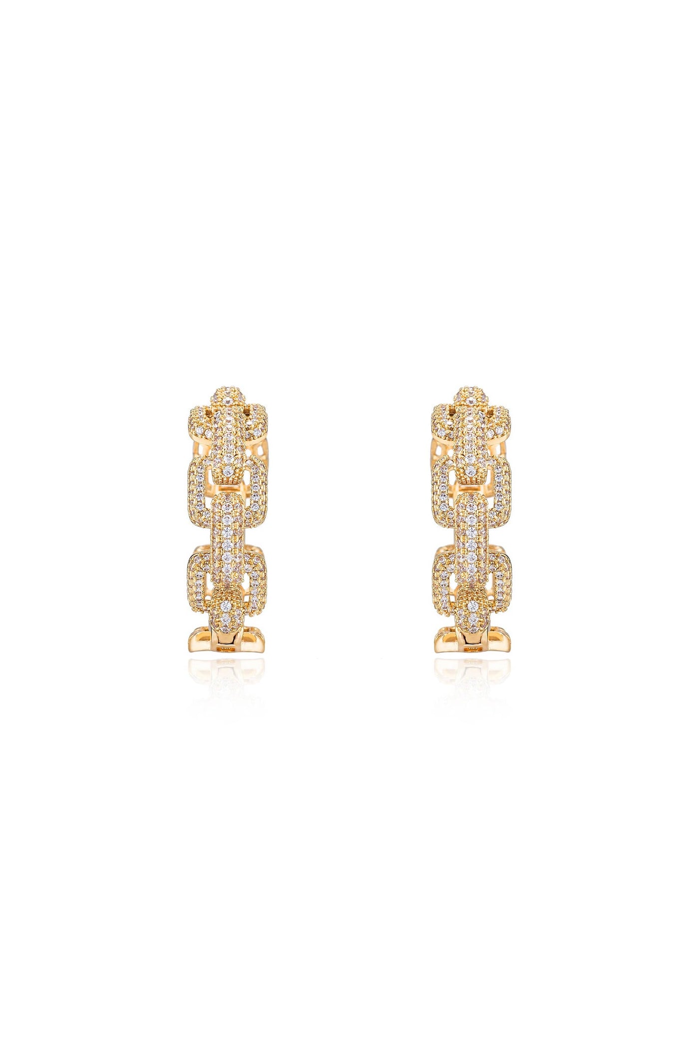 Gold earrings featuring intricate chain-like designs, adorned with sparkling gemstones. They are positioned symmetrically on a reflective surface against a plain white background, enhancing their shine and elegance.