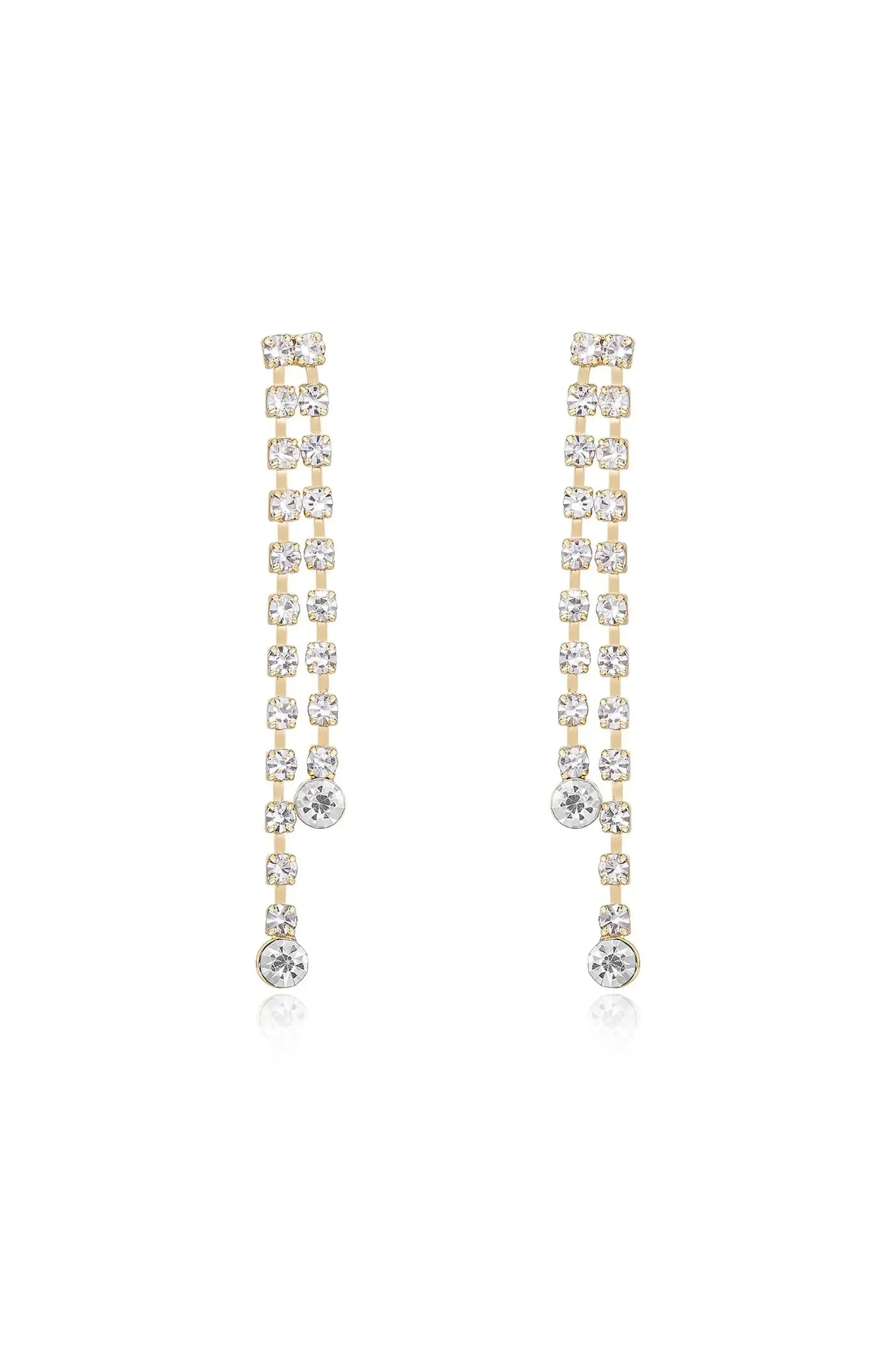 Elegant earrings featuring a series of shimmering clear crystals arranged in a vertical line, hanging gracefully, with a golden base reflecting light against a bright background.