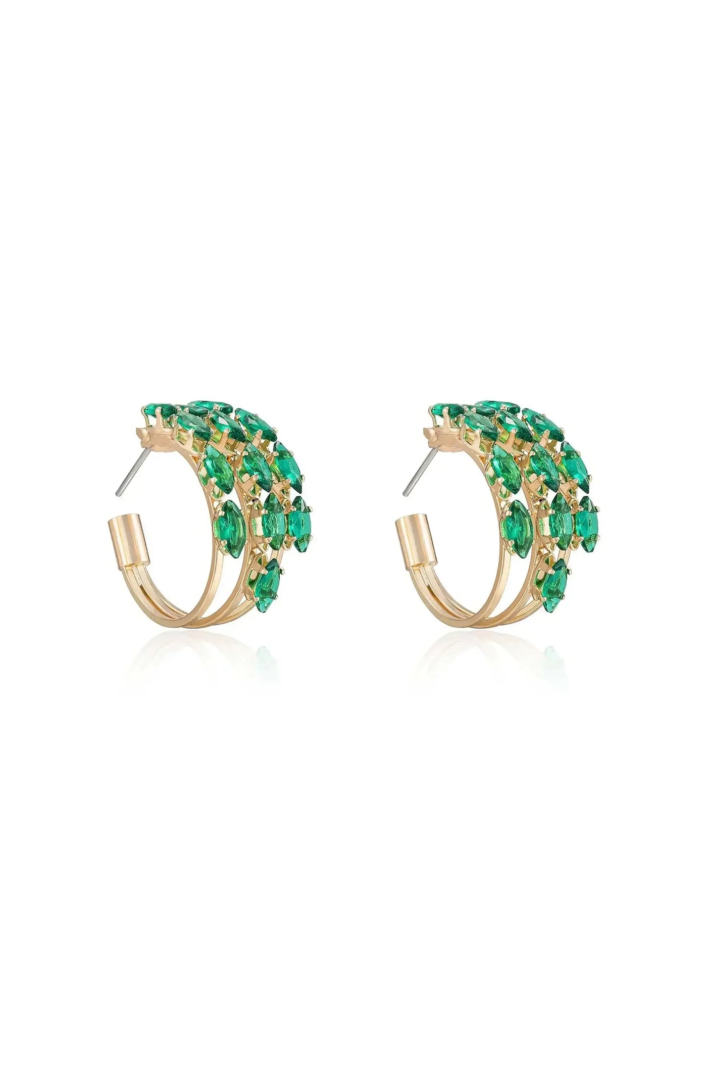 Golden hoop earrings, adorned with vibrant green gemstones, are displayed together. The earrings shimmer against a white background, highlighting their elegant design and intricate detailing.