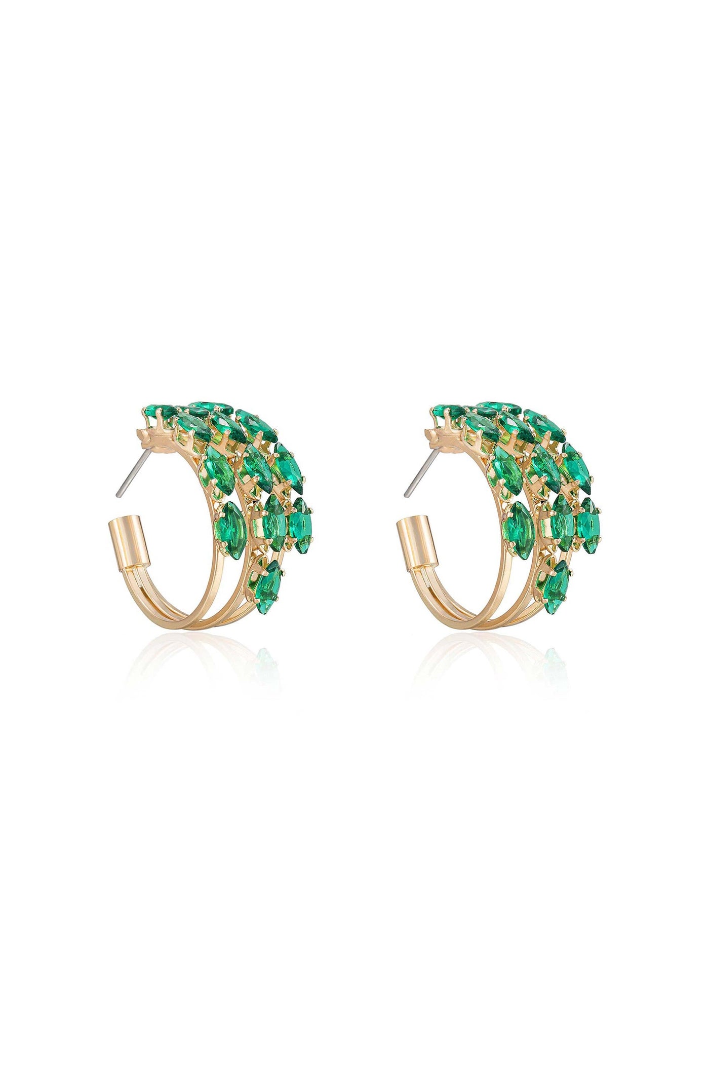 Golden hoop earrings, adorned with vibrant green gemstones, are displayed together. The earrings shimmer against a white background, highlighting their elegant design and intricate detailing.
