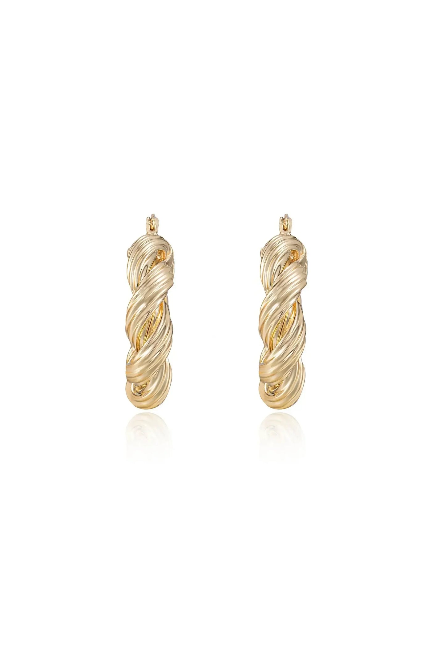 Gold twisted hoop earrings are prominently displayed, reflecting light. They appear to be elegantly crafted with a spiral design, creating a sophisticated look in a clean, minimalist setting.