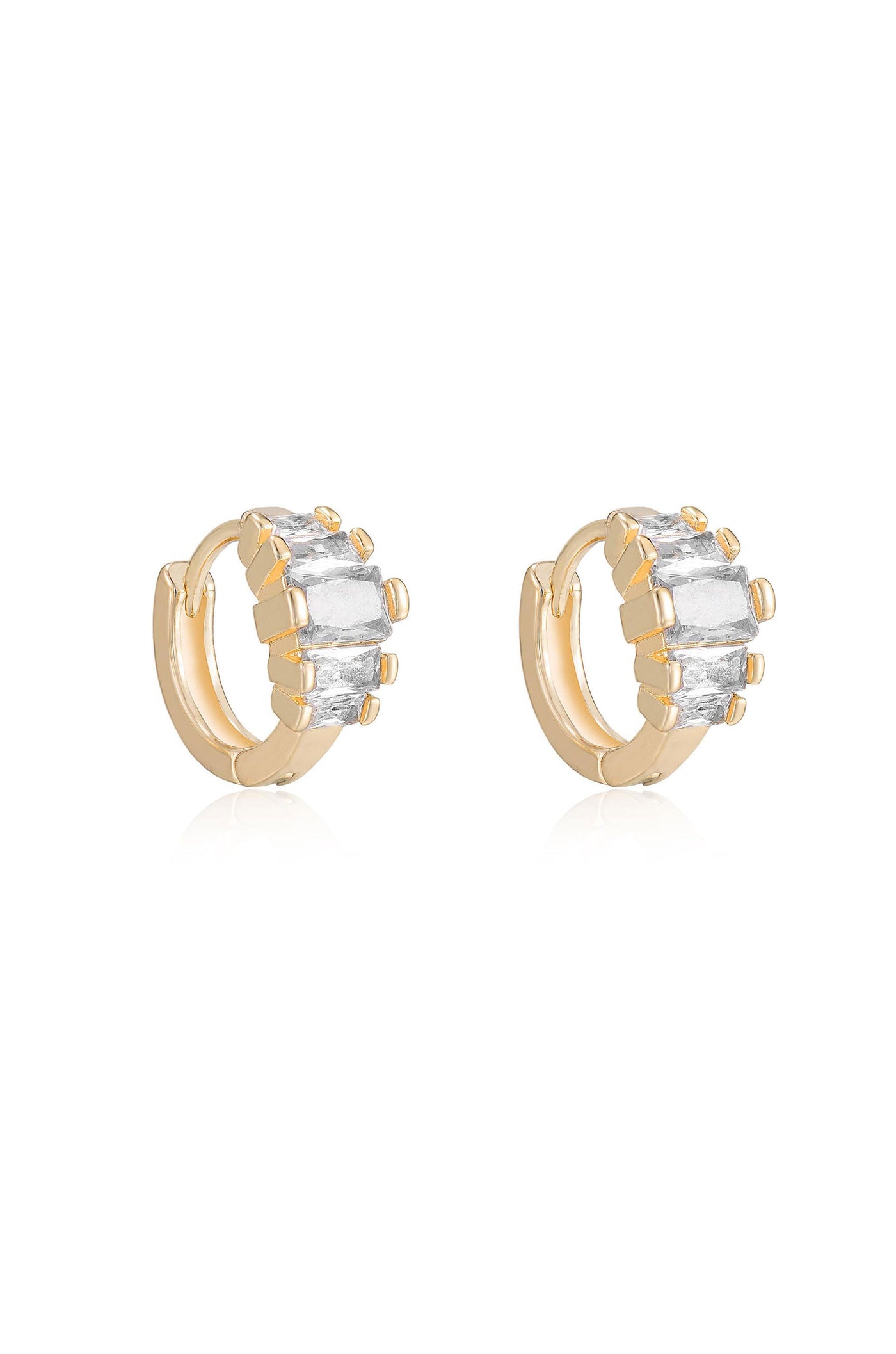 Two gold hoop earrings are displayed, each adorned with multiple rectangular and round gemstones. They sit on a reflective surface against a plain white background, emphasizing their design and shine.
