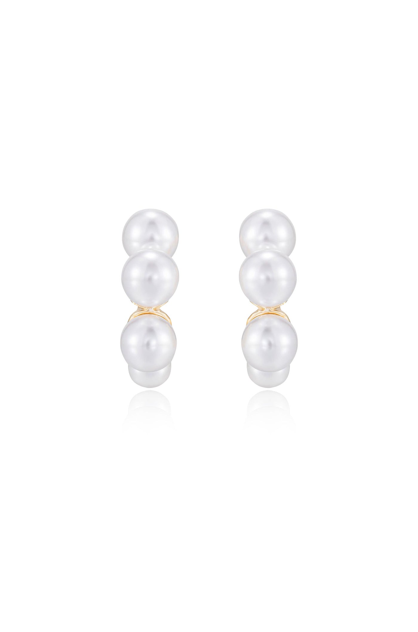 Two pairs of pearl earrings are displayed, showcasing three smooth, shiny pearls stacked vertically. The earrings reflect light against a simple, white background, highlighting their elegance.