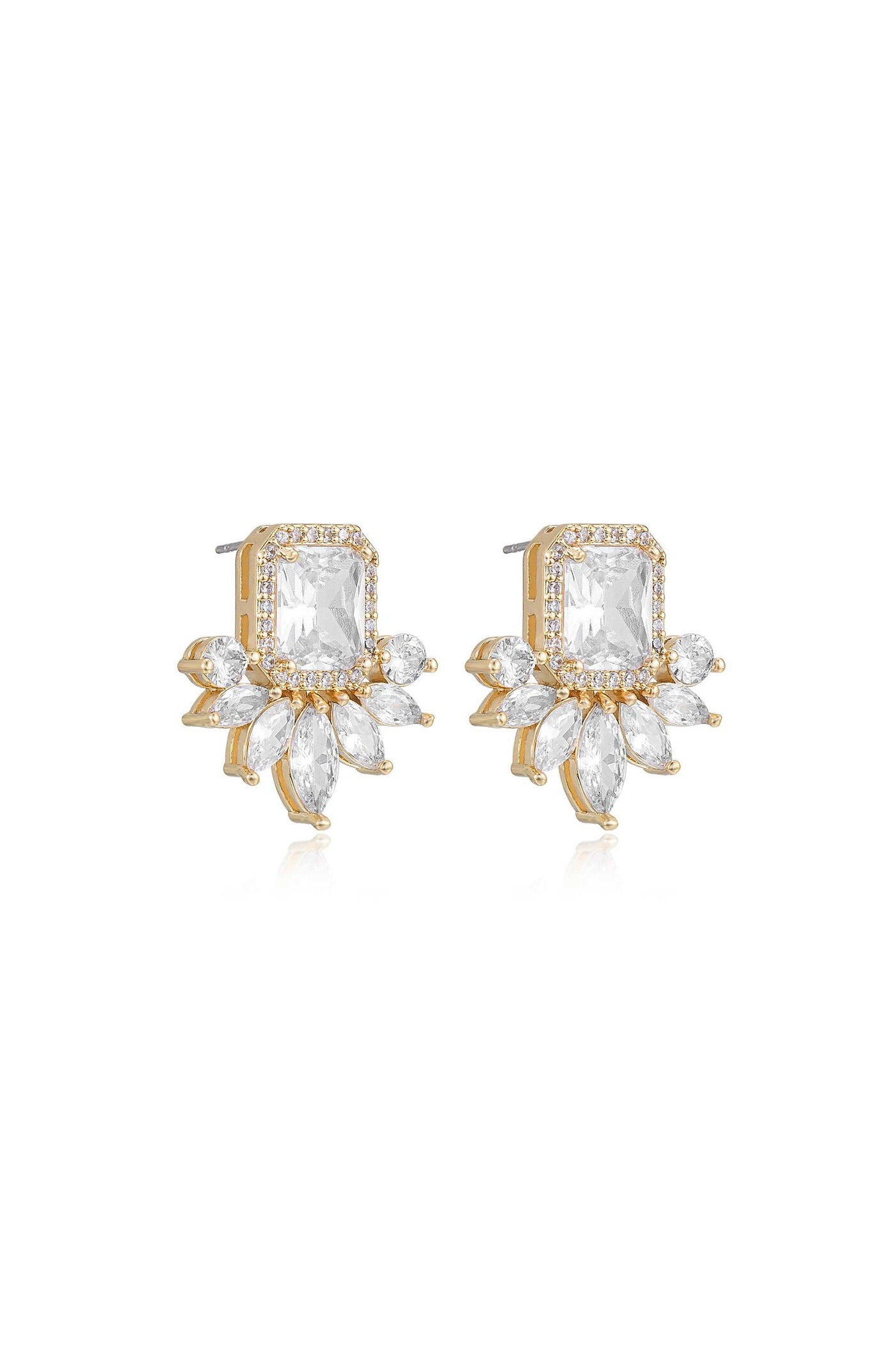 A pair of gold and clear crystal earrings features a rectangular center stone surrounded by smaller, marquise-shaped stones, glimmering against a reflective surface, suggesting elegance and luxury.