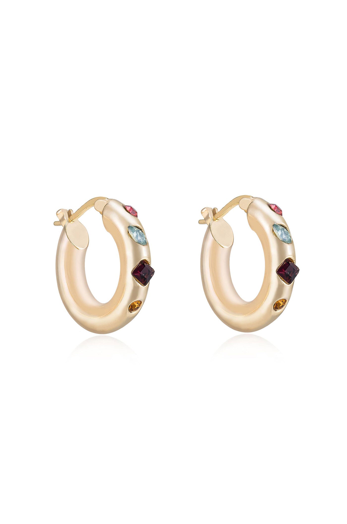 Gold hoop earrings are displayed, featuring colorful gemstones embedded along their surface. The earrings are elegantly shaped and shine against a plain white background, emphasizing their luxury and style.