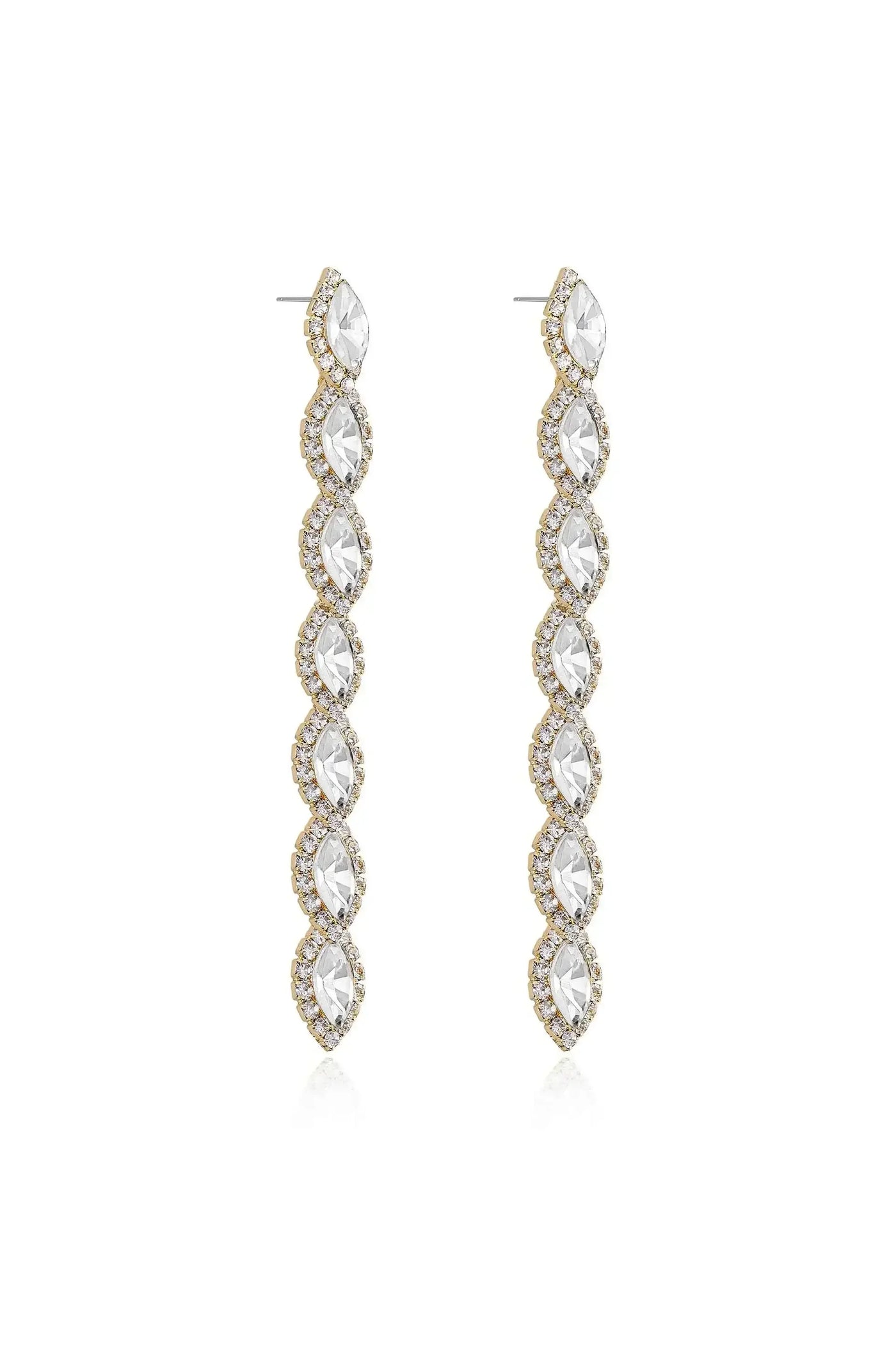 Two long, shimmering earrings hang vertically, featuring a series of marquise-cut stones encircled by small crystals. They are set against a plain, light background.