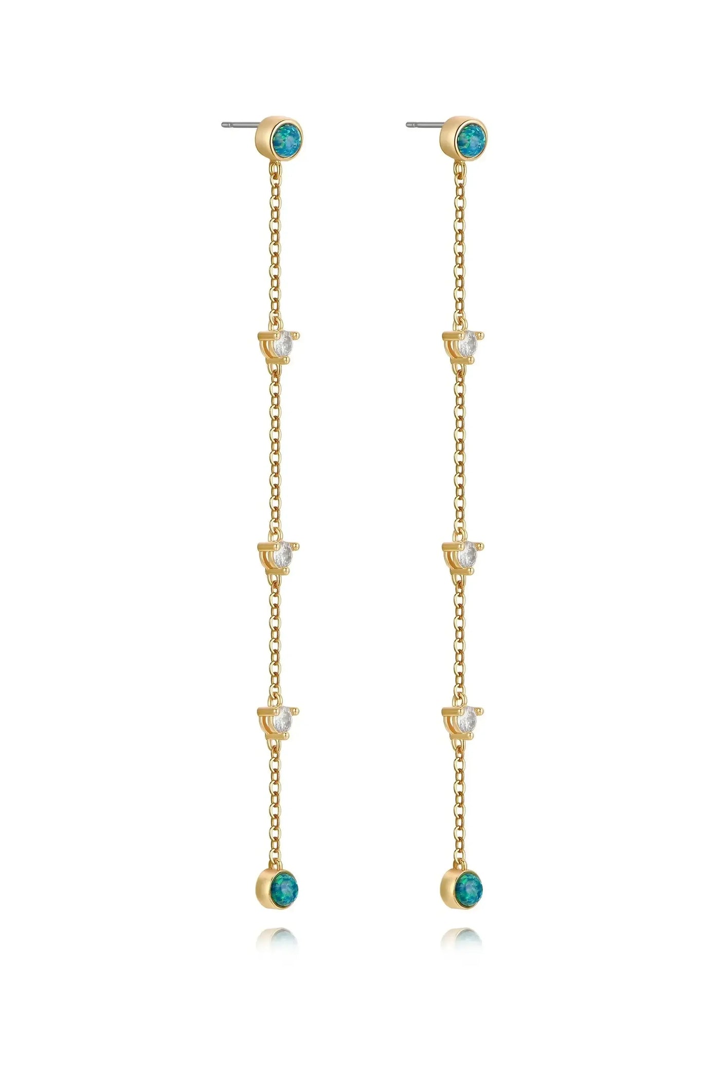 Elegant gold earrings hang vertically, featuring a chain design with alternating turquoise and clear gemstones, enhancing their luxurious appearance against a white background.