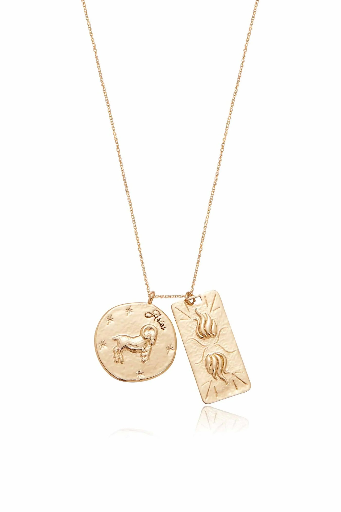 A gold necklace features two pendants: a round one with a ram and “Aries†inscribed, and a rectangular one with stylized flames, both hanging from a delicate chain against a white background.