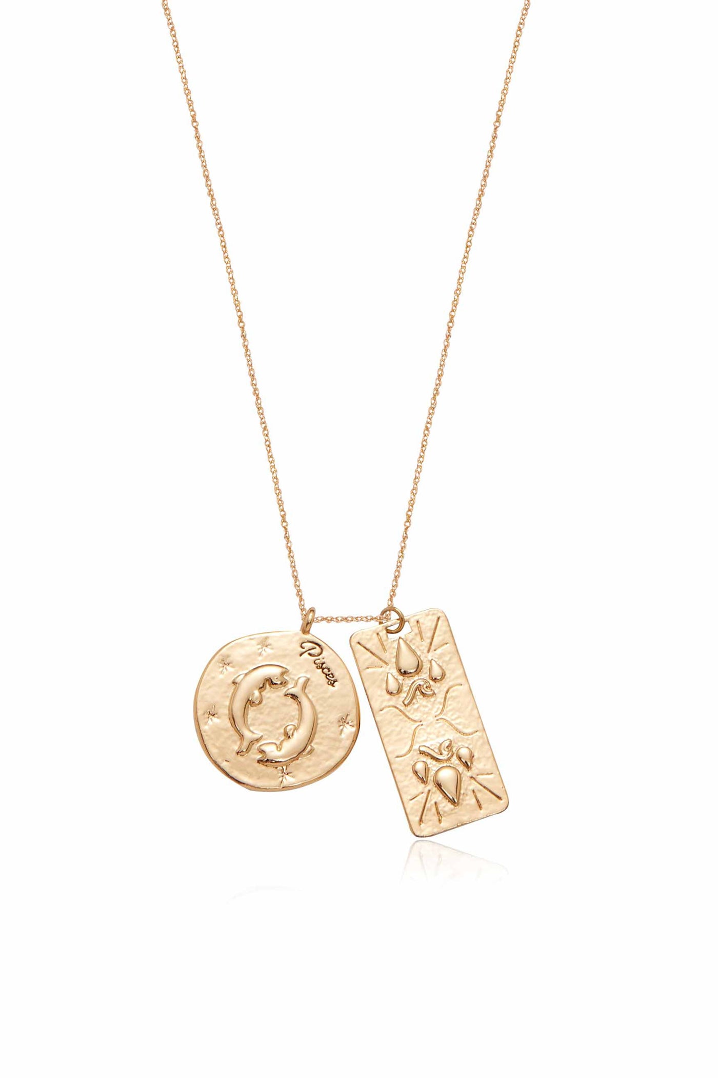 A gold necklace features two pendants: a circular one with the word "Pisces" and depicted dolphins, and a rectangular one with drop and wave patterns.