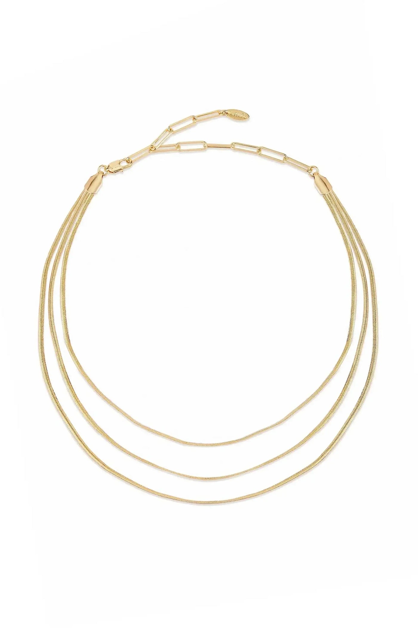 A three-strand gold necklace lies flat, displaying its sleek, shiny texture. It features delicate links and a clasp, set against a plain white background, emphasizing its elegance.
