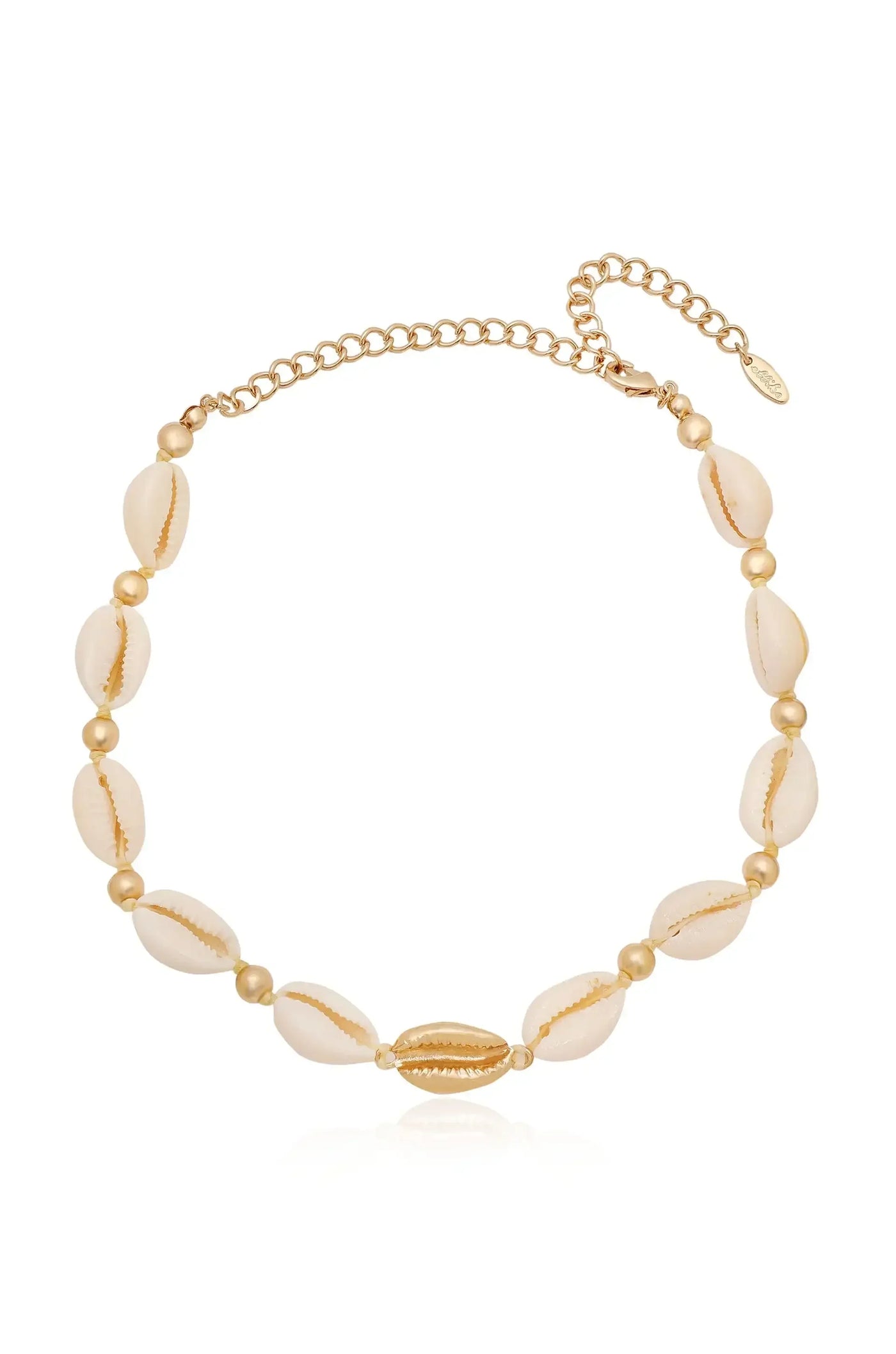 A necklace made of golden beads and cowrie shells, showcasing a combination of natural textures and metallic shine, rests against a light background, emphasizing its elegance and beach-inspired design.
