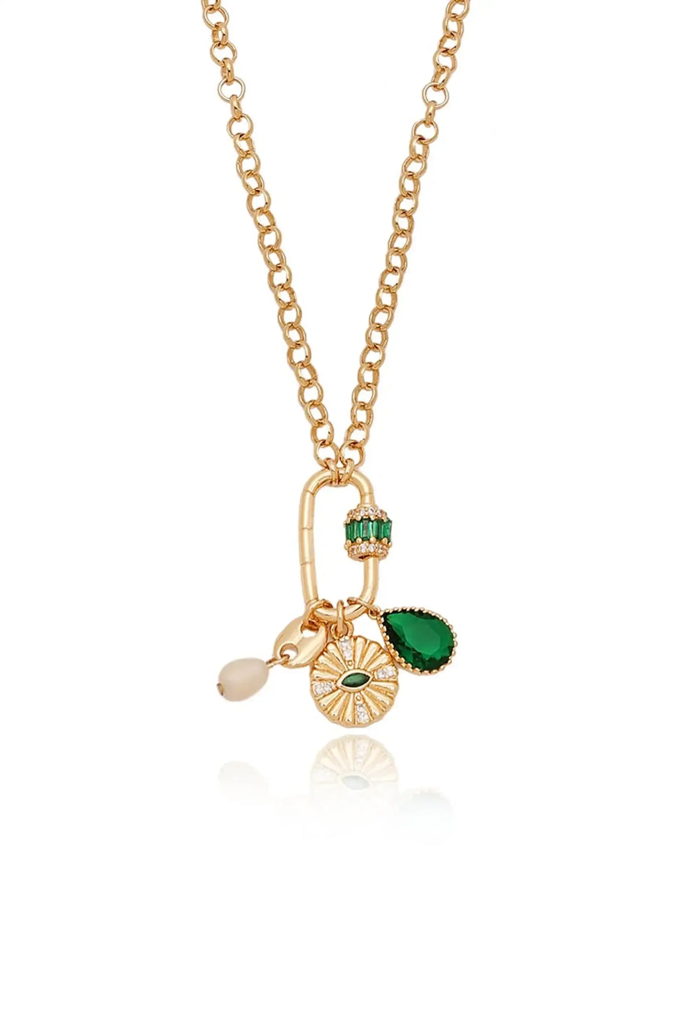 A gold chain necklace features colorful charms, including a green teardrop gem, a textured circular pendant with a green center, and a white bead, all against a reflective white background.