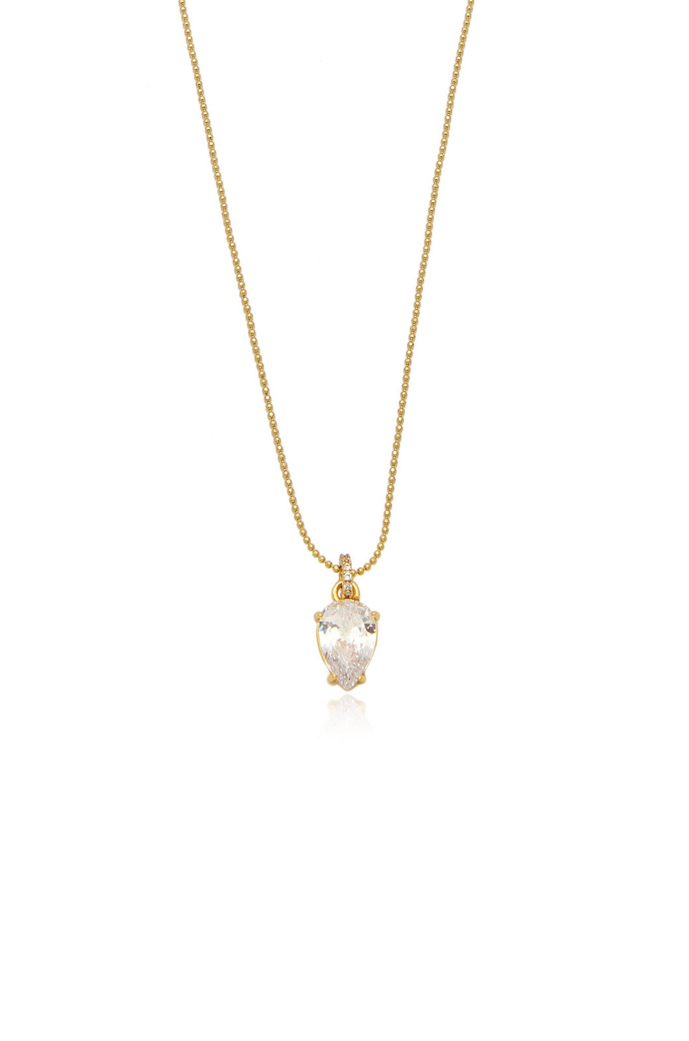 A gold necklace features a pear-shaped crystal pendant, elegantly suspended and catching light, creating a shimmering effect. The design is simple yet sophisticated, suitable for various occasions.
