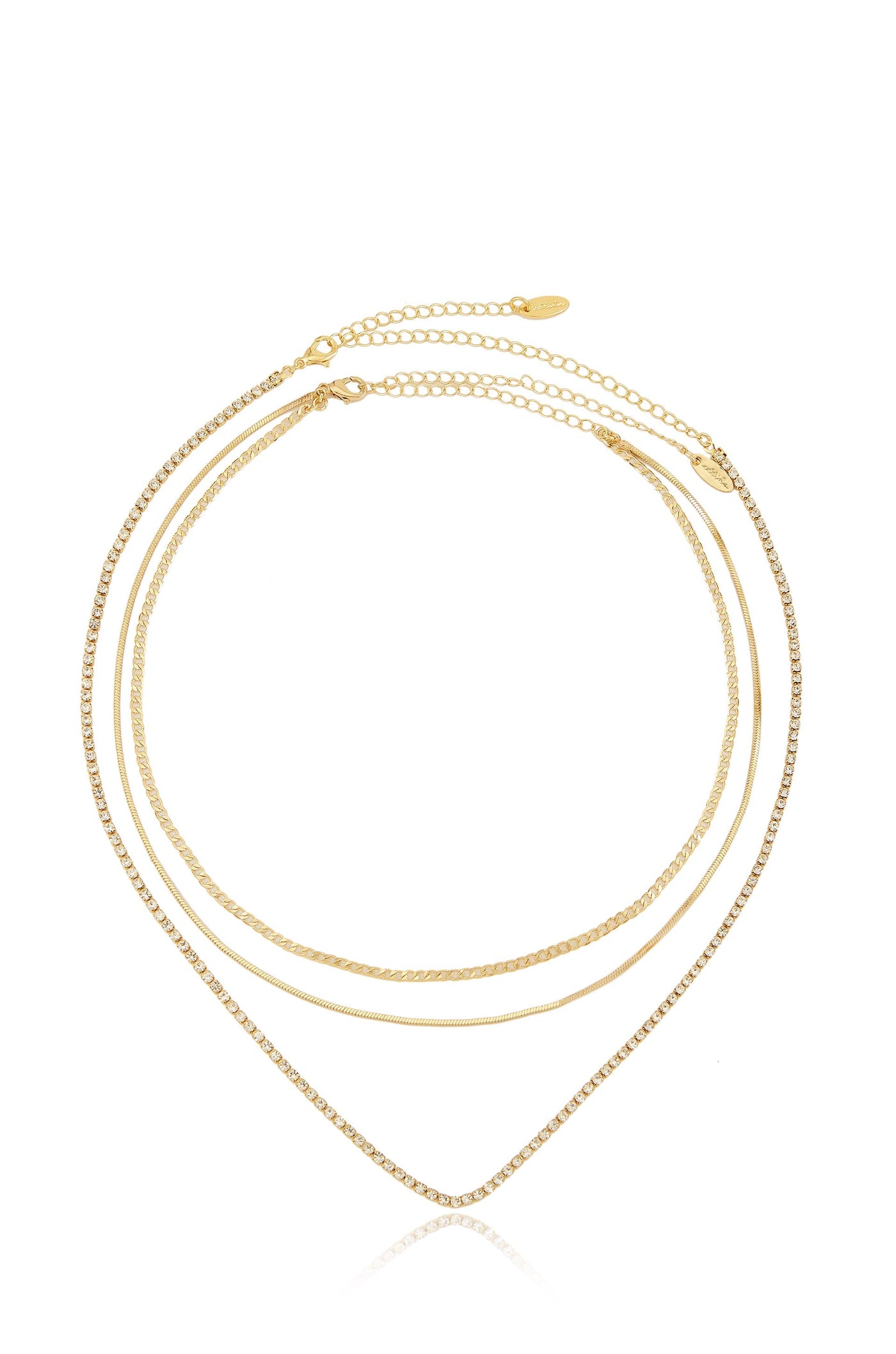 A three-strand gold necklace with varying textures, including a sparkling chain, drapes elegantly in a V shape, reflecting on a clean, white background that enhances its shine.