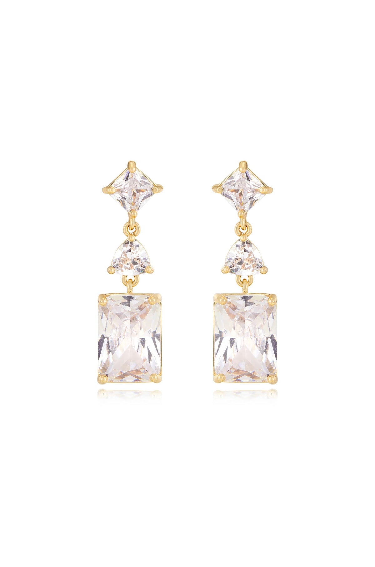 Gold earrings featuring a symmetrical design comprise an upper triangular gemstone, a smaller round gemstone, and a larger rectangular gemstone, reflecting light against a neutral background.