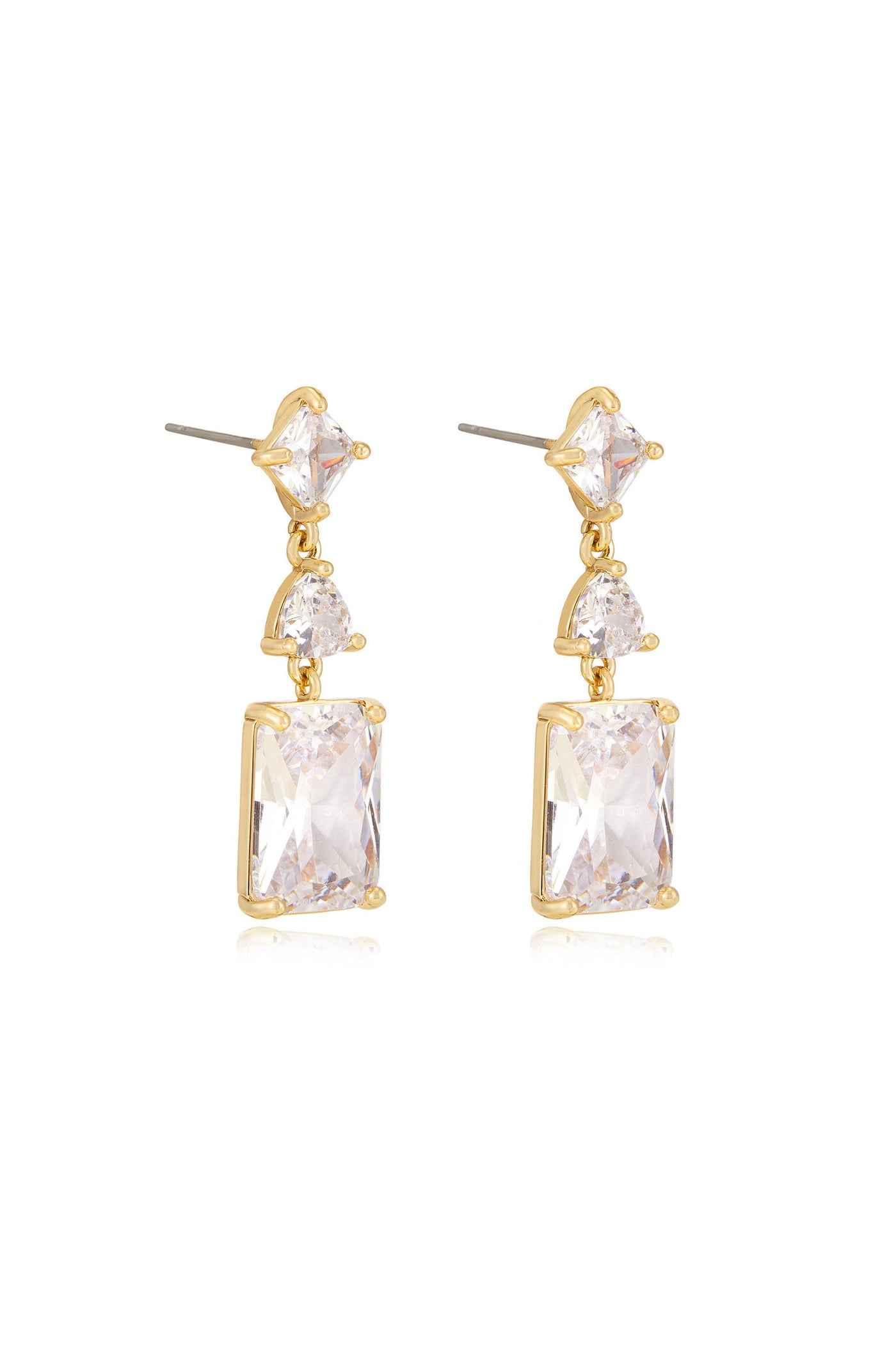 Two elegant gold earrings are displayed, featuring a dangling design with clear sparkling gemstones. They are set against a reflective surface that enhances their shine.