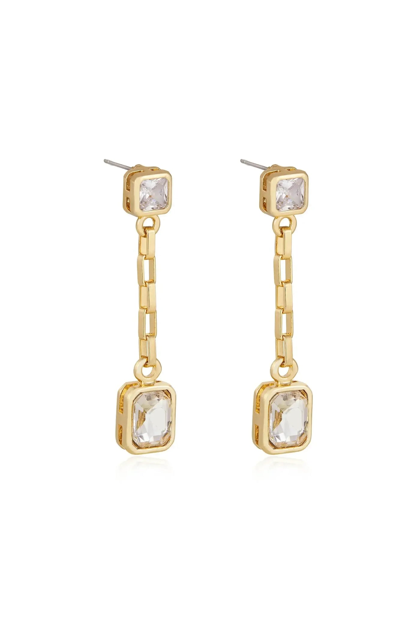 Two gold-tone earrings feature a linear design with a rectangular clear stone at the top and a larger rectangular stone at the bottom, suspended by a delicate chain.