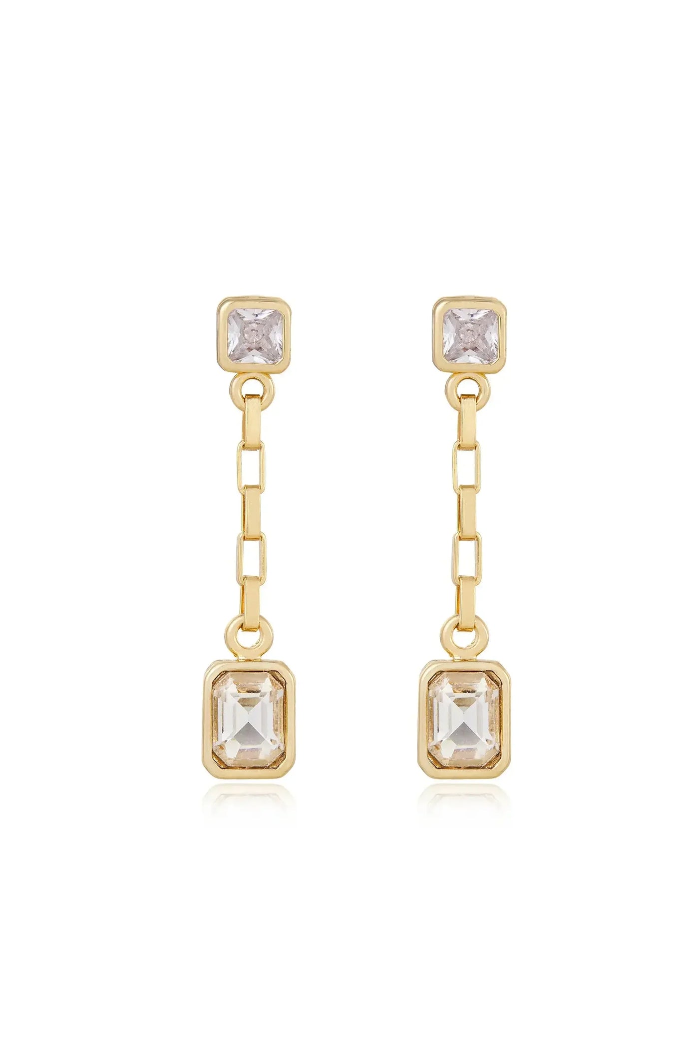 Dangling earrings feature two rectangular gems, one at the top and one at the bottom, linked by a chain in a gold setting. The design exudes elegance and sophistication.