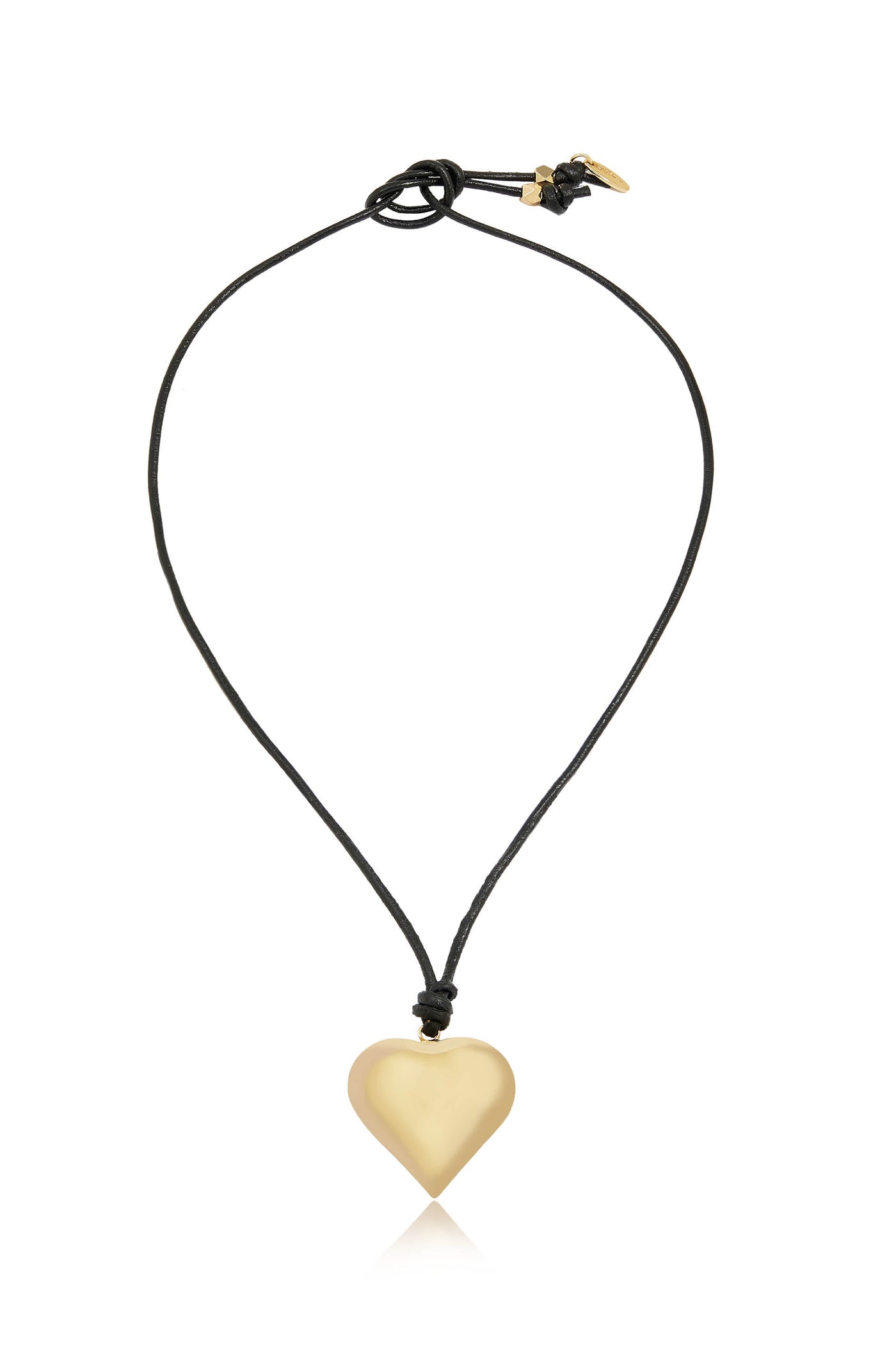 A gold heart-shaped pendant hangs from a black cord, creating a simple yet elegant necklace. The pendant reflects light, enhancing its smooth, shiny surface against a plain background.