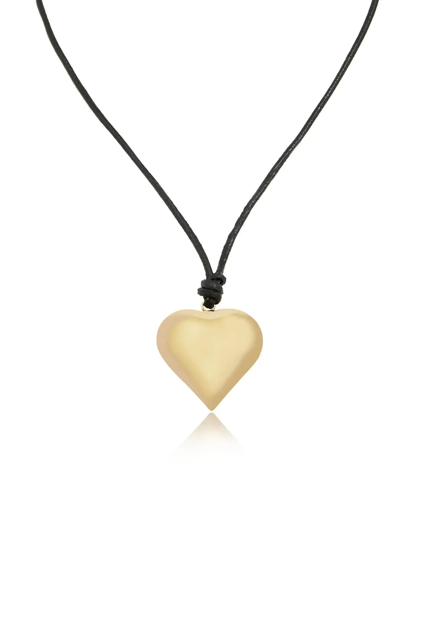 A heart-shaped pendant made of smooth, shiny material hangs from a black cord, reflecting light against a plain, white background. It exudes a simple, elegant design.