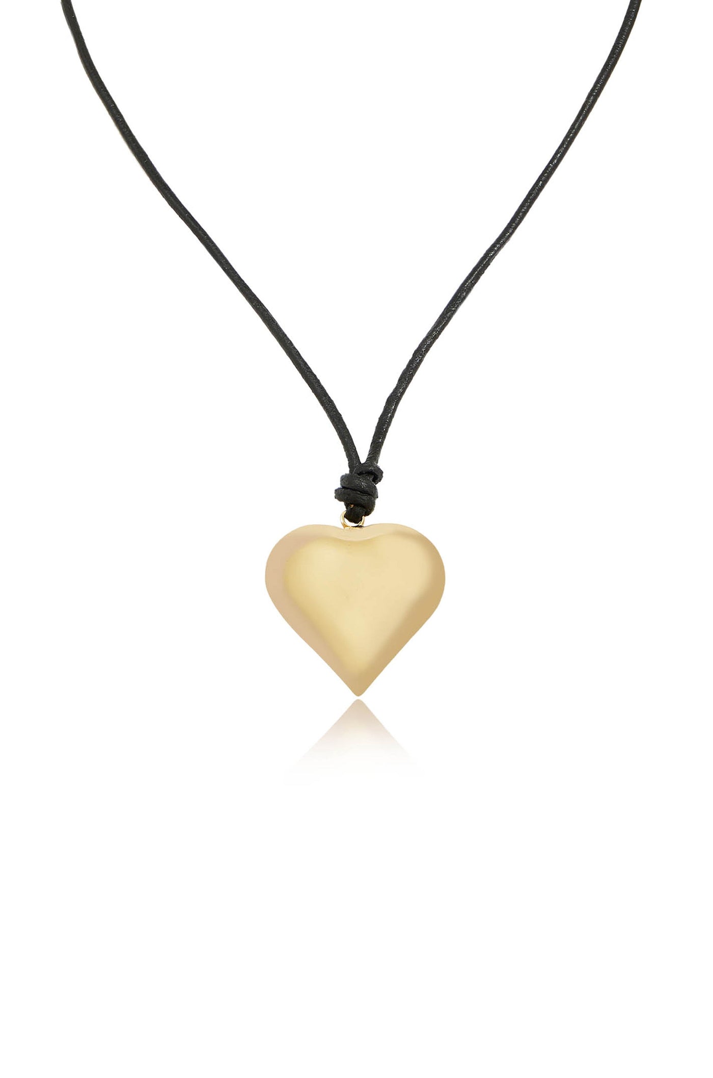 A heart-shaped pendant made of smooth, shiny material hangs from a black cord, reflecting light against a plain, white background. It exudes a simple, elegant design.
