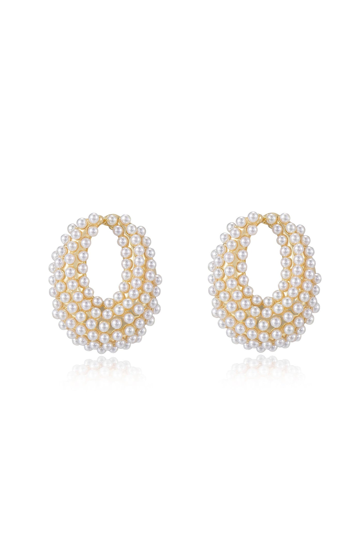 Two large hoop earrings, adorned with multiple small pearls arranged in layers, showcase a reflective surface and a golden outline, set against a simple, light background.