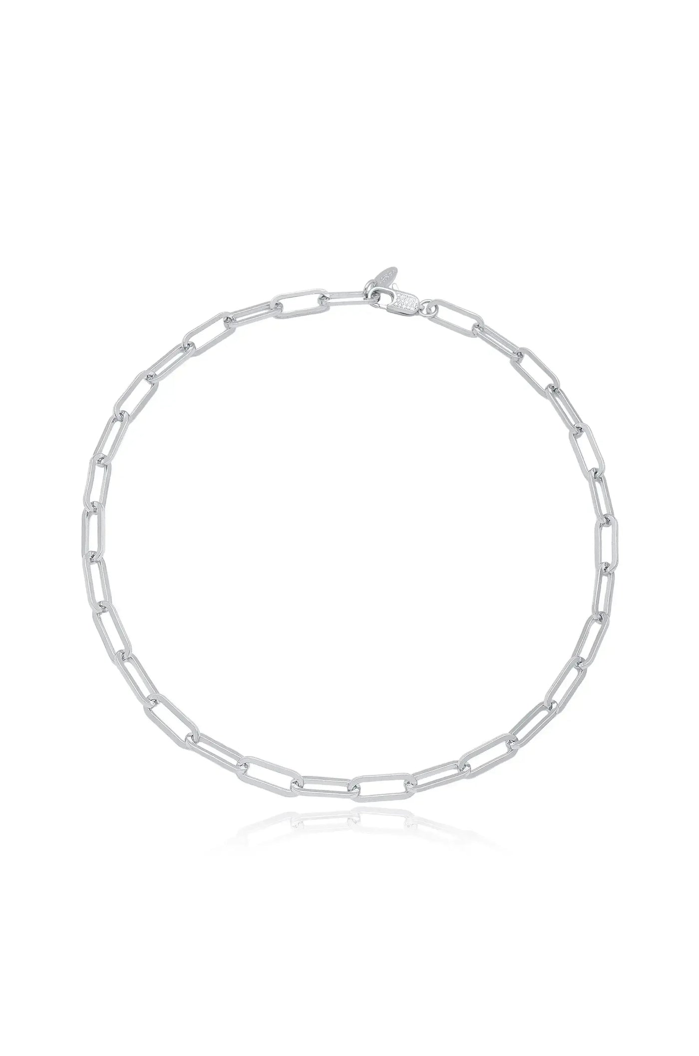 A silver chain necklace lies flat, displaying elongated rectangular links connected in a symmetrical pattern. It is set against a plain background, highlighting its sleek design and reflective surface.