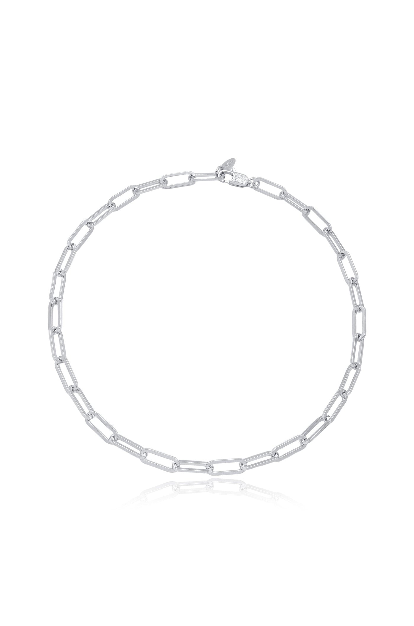 A silver chain necklace lies flat, displaying elongated rectangular links connected in a symmetrical pattern. It is set against a plain background, highlighting its sleek design and reflective surface.