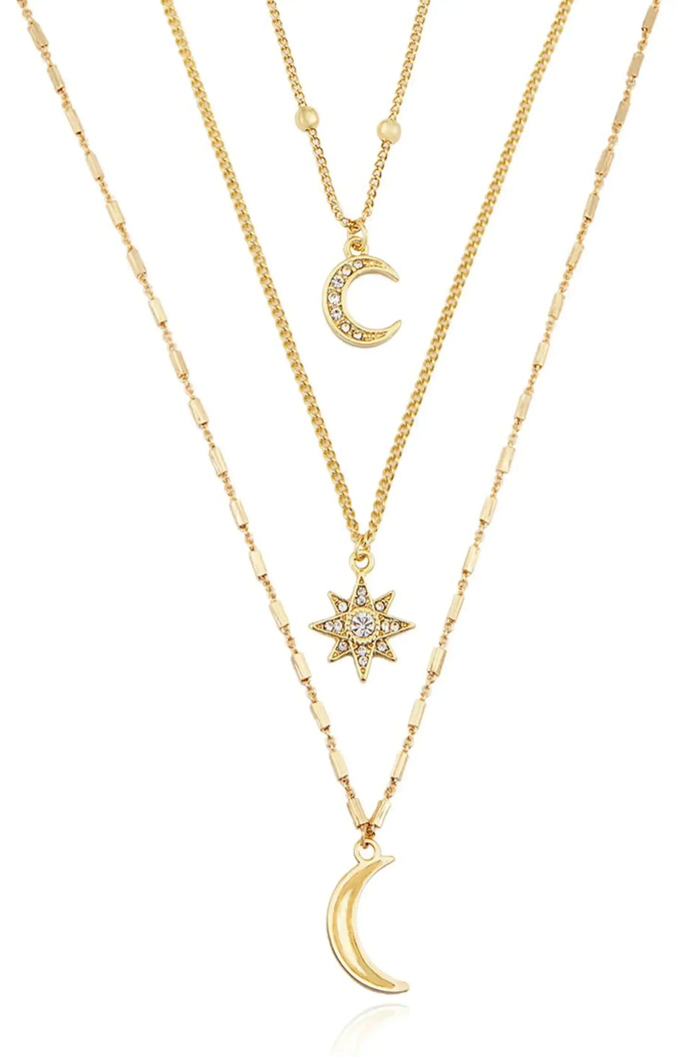 Three layered gold necklaces are displayed. The top features a simple chain, the middle has a crescent moon pendant with rhinestones, and the bottom showcases a star pendant, all on a white background.