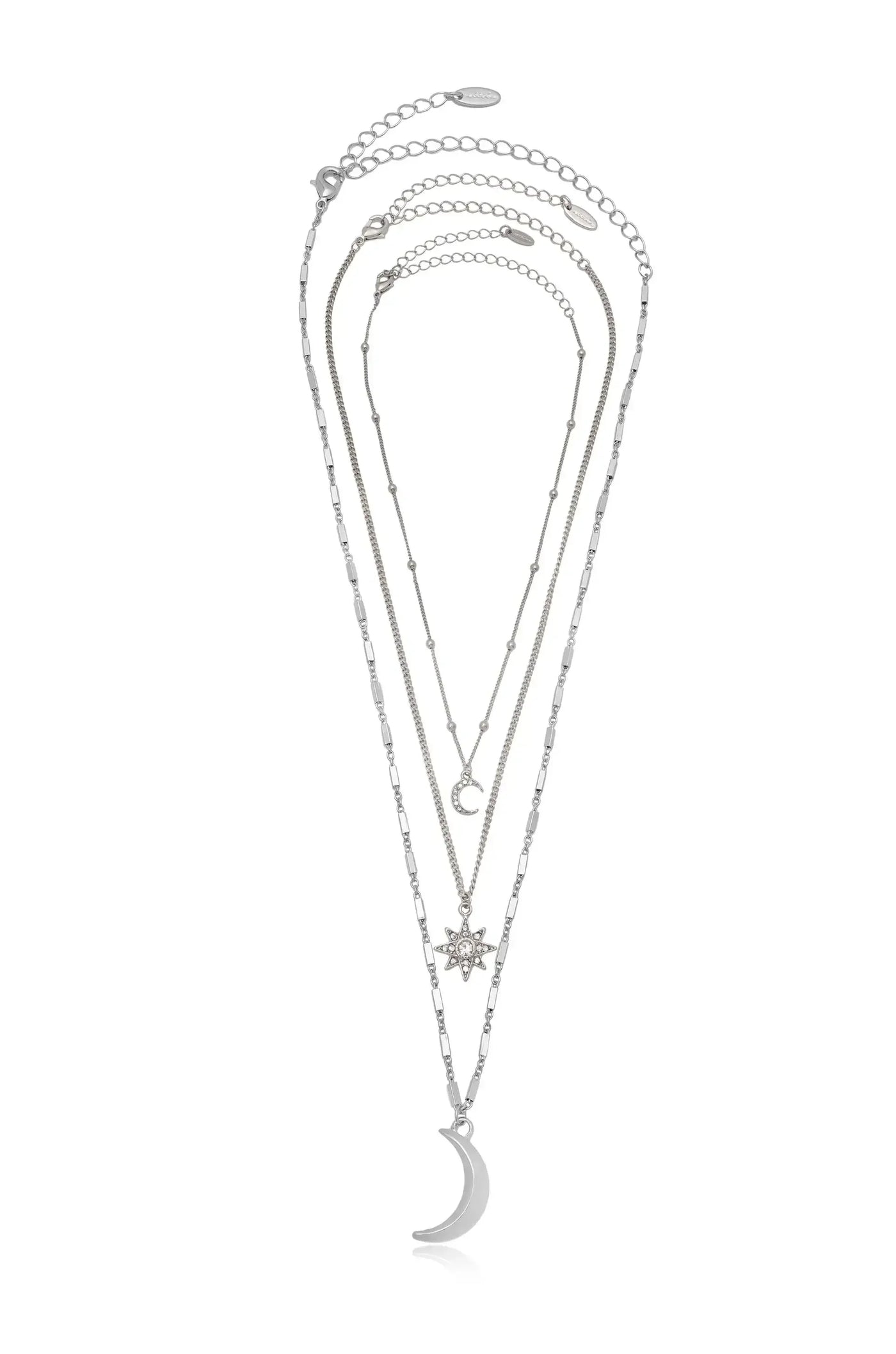 A set of three layered silver necklaces, featuring a crescent moon, a star pendant, and a small moon charm, are displayed against a white background.