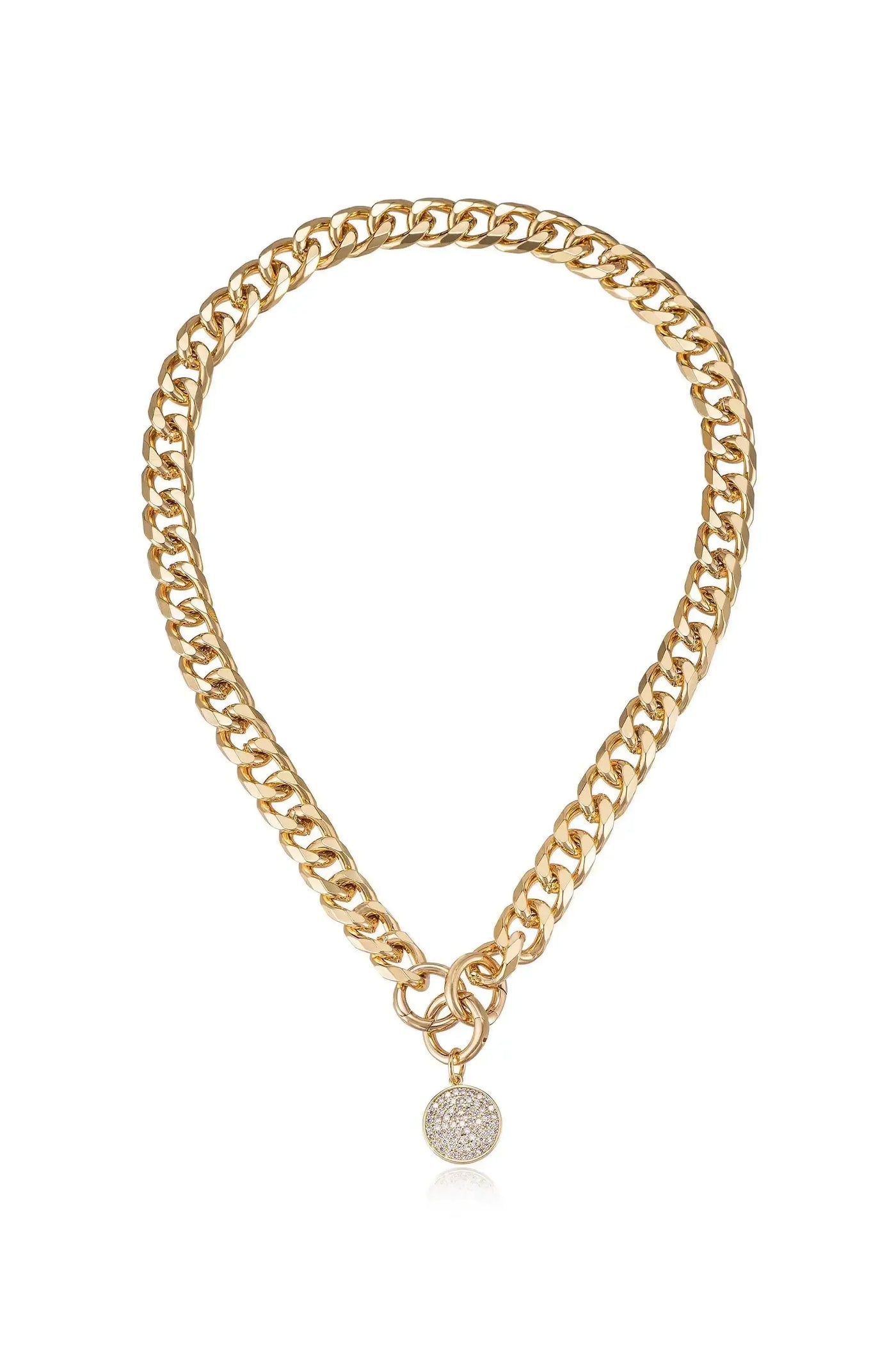 A gold chain necklace features thick, interlocking links with a circular charm adorned with small sparkling stones, suspended centrally. The background is simple, emphasizing the jewelry’s shine and design.