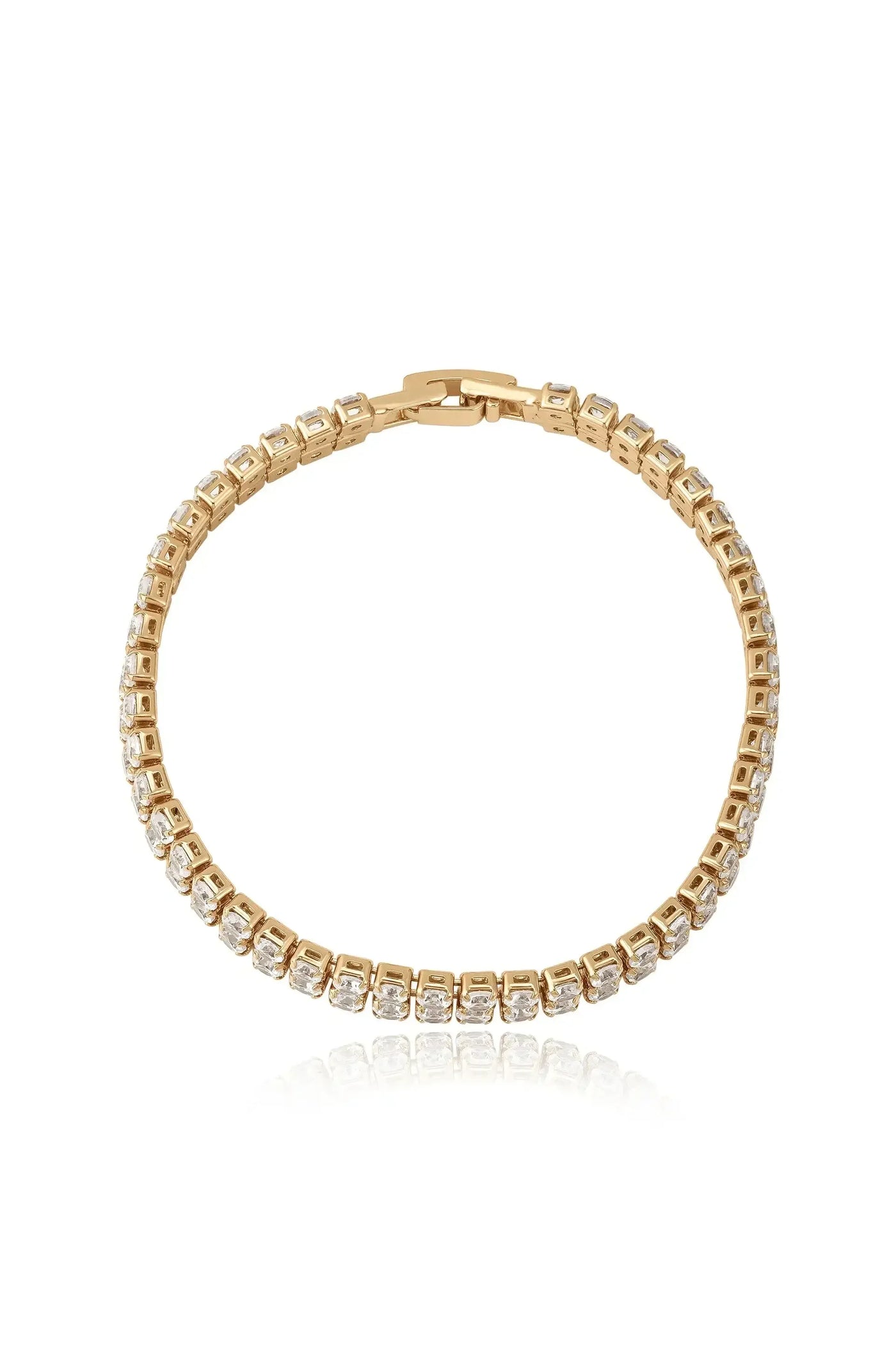 A gold bracelet adorned with square-cut stones shines brightly. It rests flat, reflecting light against a plain white background, highlighting its elegant design and luxurious finish.
