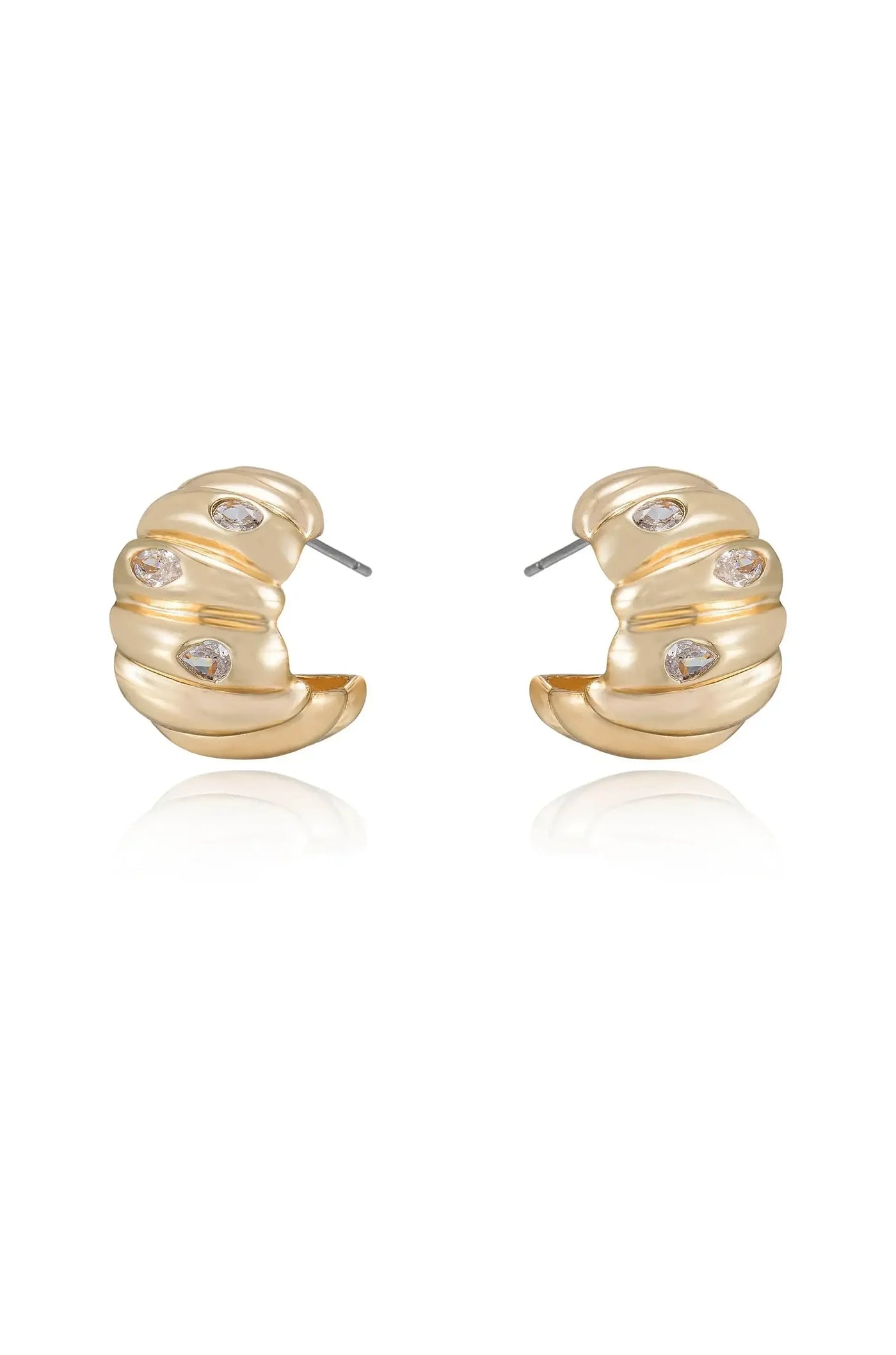 Gold-toned earrings with a scalloped design and small, sparkling gems. They are displayed against a white background, highlighting their reflective surfaces and elegant contours.