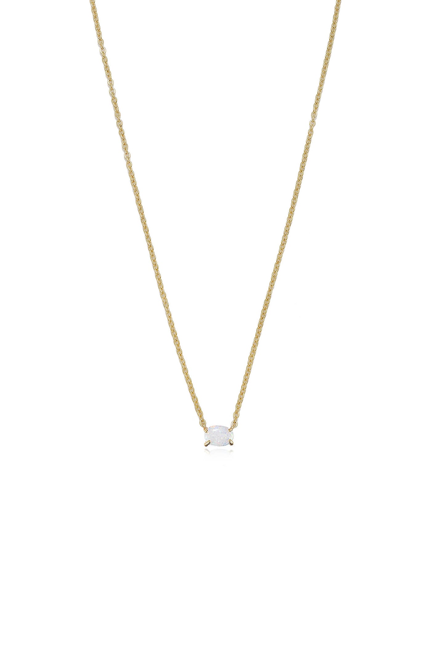 A delicate gold necklace features a central oval gemstone, suspended from a fine chain. It rests against a plain white background, highlighting its elegance and shimmering details.